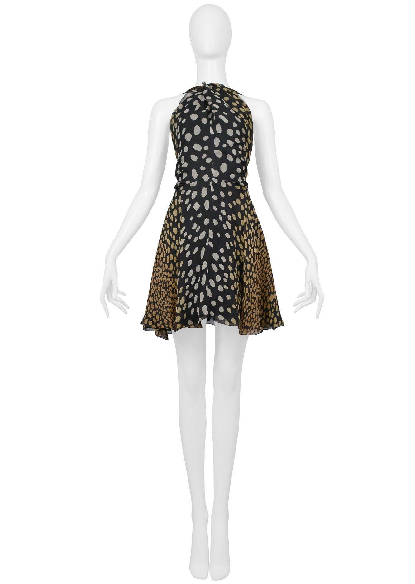 Christian Dior by John Galliano black and beige silk speckle print halter dress with black harness straps with grommets and silver tone buckles. Dress was featured on the runway and in advertising. Collection SS 2009.