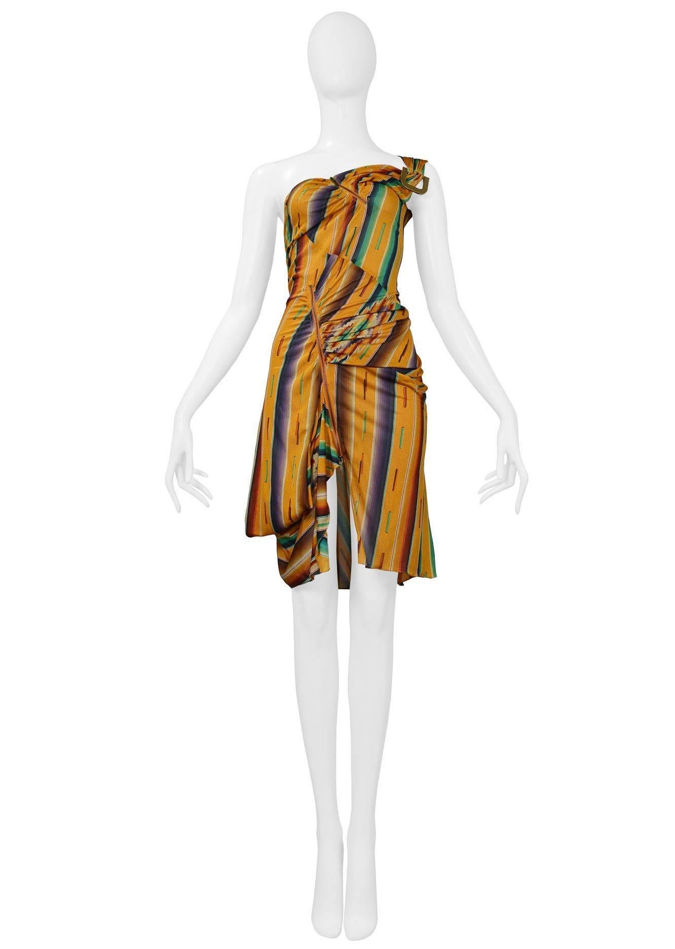 Christian Dior by John Galliano multi colored Navajo style stripe jersey dress with asymmetrical neckline and hem. Dress features brass hardware at shoulder and brass exposed zippers throughout. Collection SS 2002.