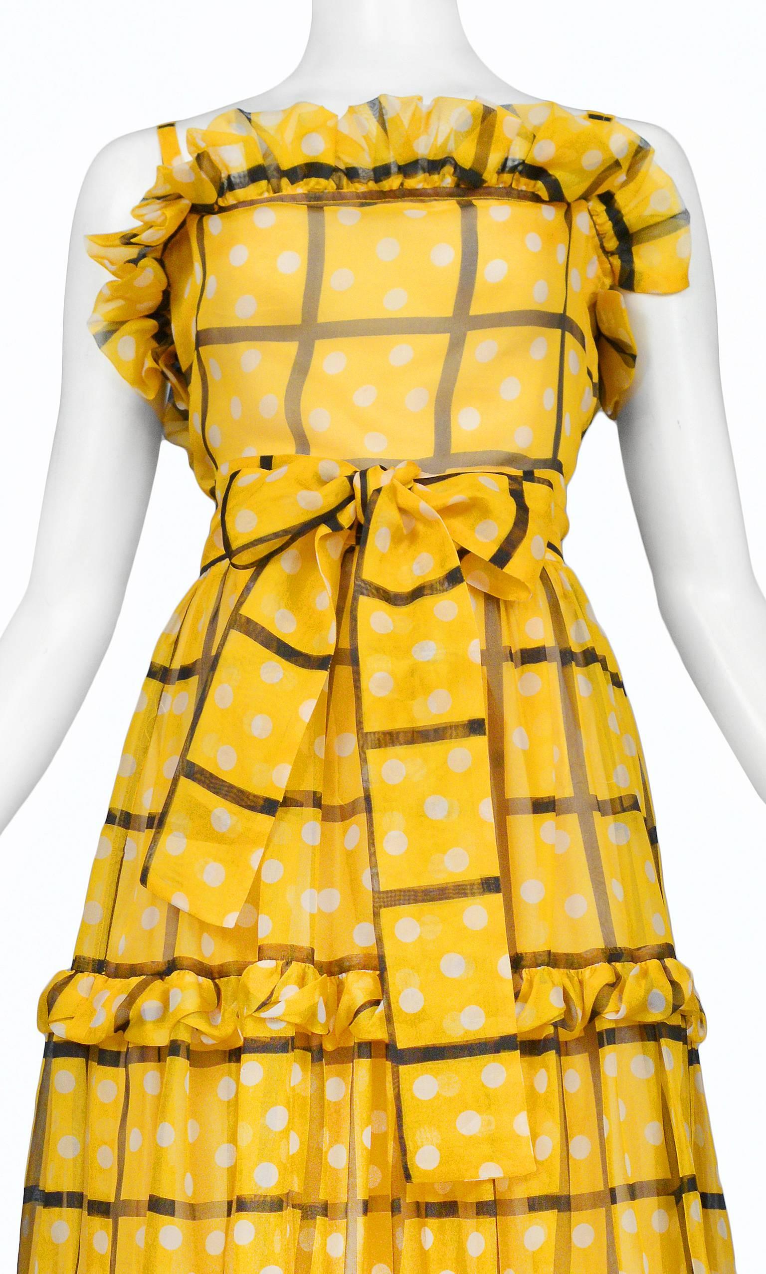 Vintage Yves Saint Laurent (YSL) marigold yellow organza "Hostess" ensemble. Top features ruffles at bust and classic straps. The skirt features 3 tiers with ruffles at the hip, knee, and hem. Matching belt that ties at waist. The ensemble