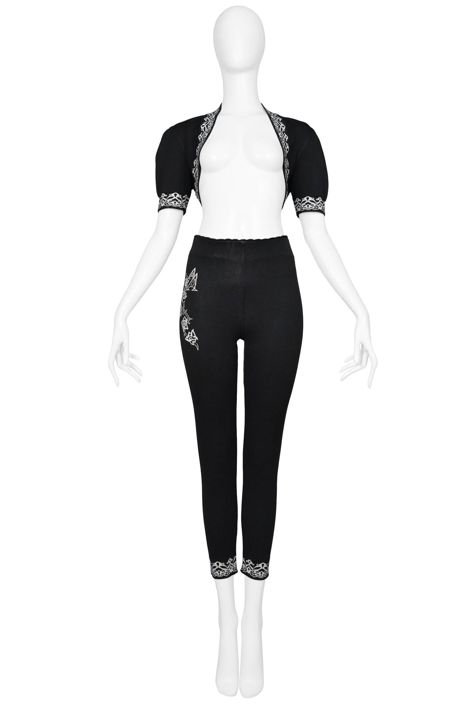 Vintage Azzedine Alaia black knit ensemble featuring a short sleeve cropped bolero cardigan with a white intarsia graphic along the sleeves and neckline.  The leggings feature matching graphic detail at the ankle bands and a double 