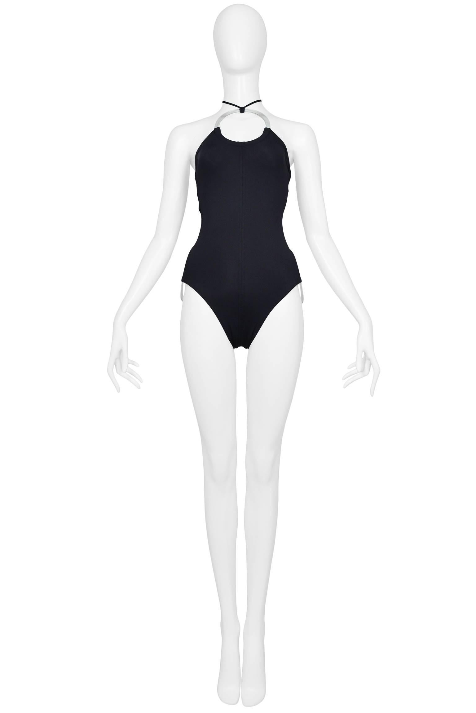 Paco Rabanne never worn futuristic mod black one-piece swimsuit with clear plastic discs at breast and hips. Suit ties at neck and has band at back. New without tags. 