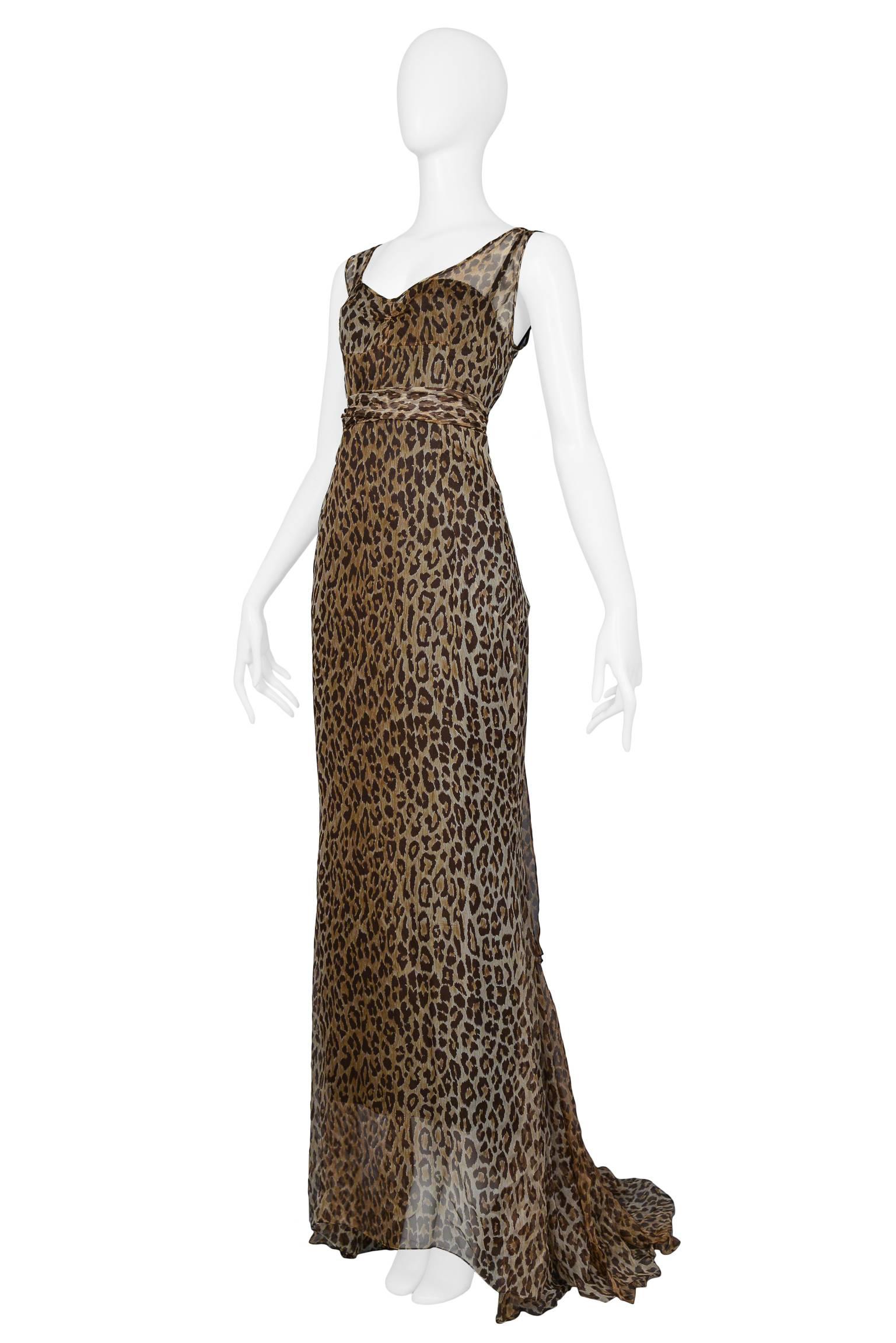 Dolce & Gabbana chiffon leopard print statement evening gown with attached under slip dress and matching sash. The dress features an open neckline, exposed upper back, full length front hem and extra long train at back. 