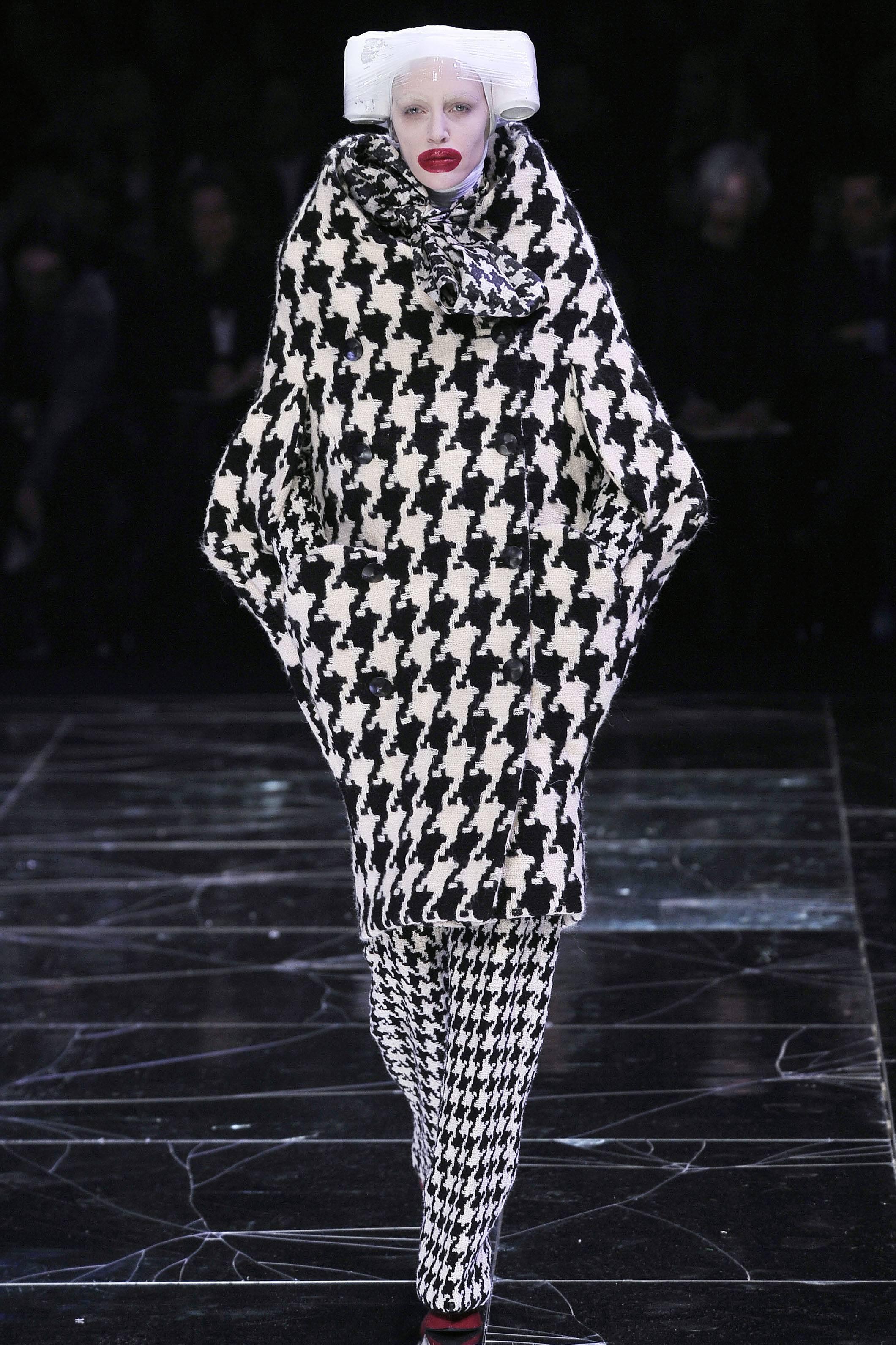 A rare and important vintage Alexander McQueen high collared black and white dogtooth check wool cocoon coat that was designed by the master McQueen himself. The coat can be worn high on the shoulders or slightly off. We have photographed the coat