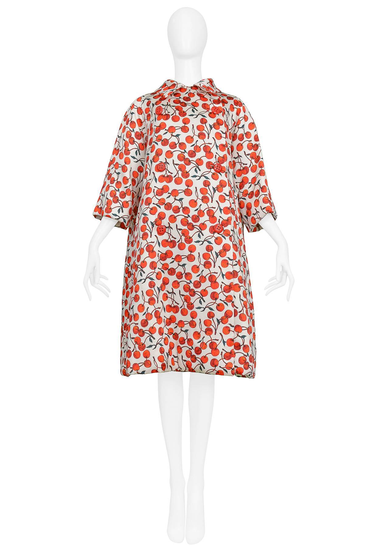 Iconic red and white cherry print Dolce & Gabbana swing style padded evening coat with red buttons. Collection 1996.