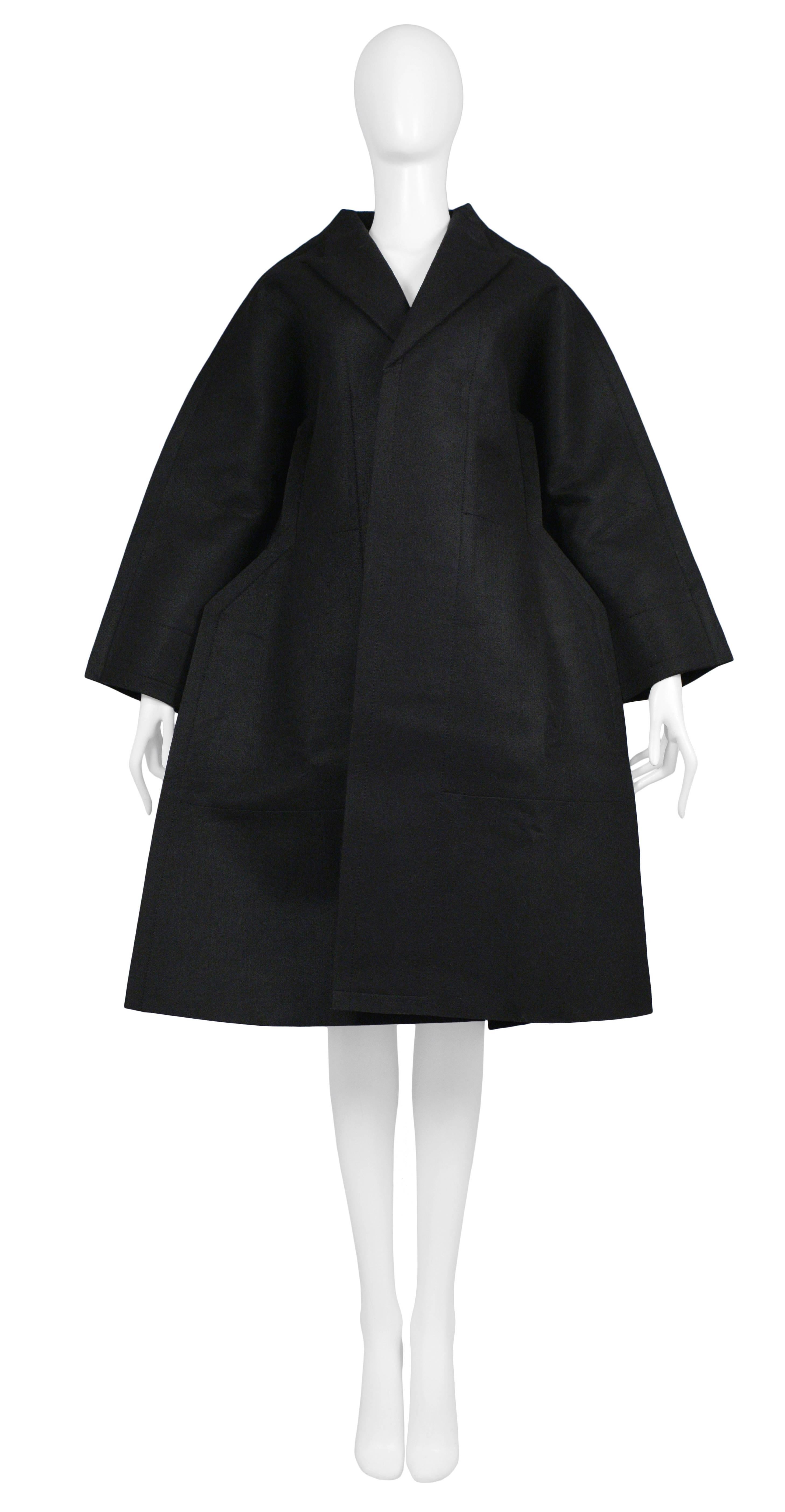 Comme des Garcons black felt 2D Flat collection coat from AW 2012. Tie at breast and inside out seams throughout. Excellent condition. Key piece for any Comme des Garcons collector. 

