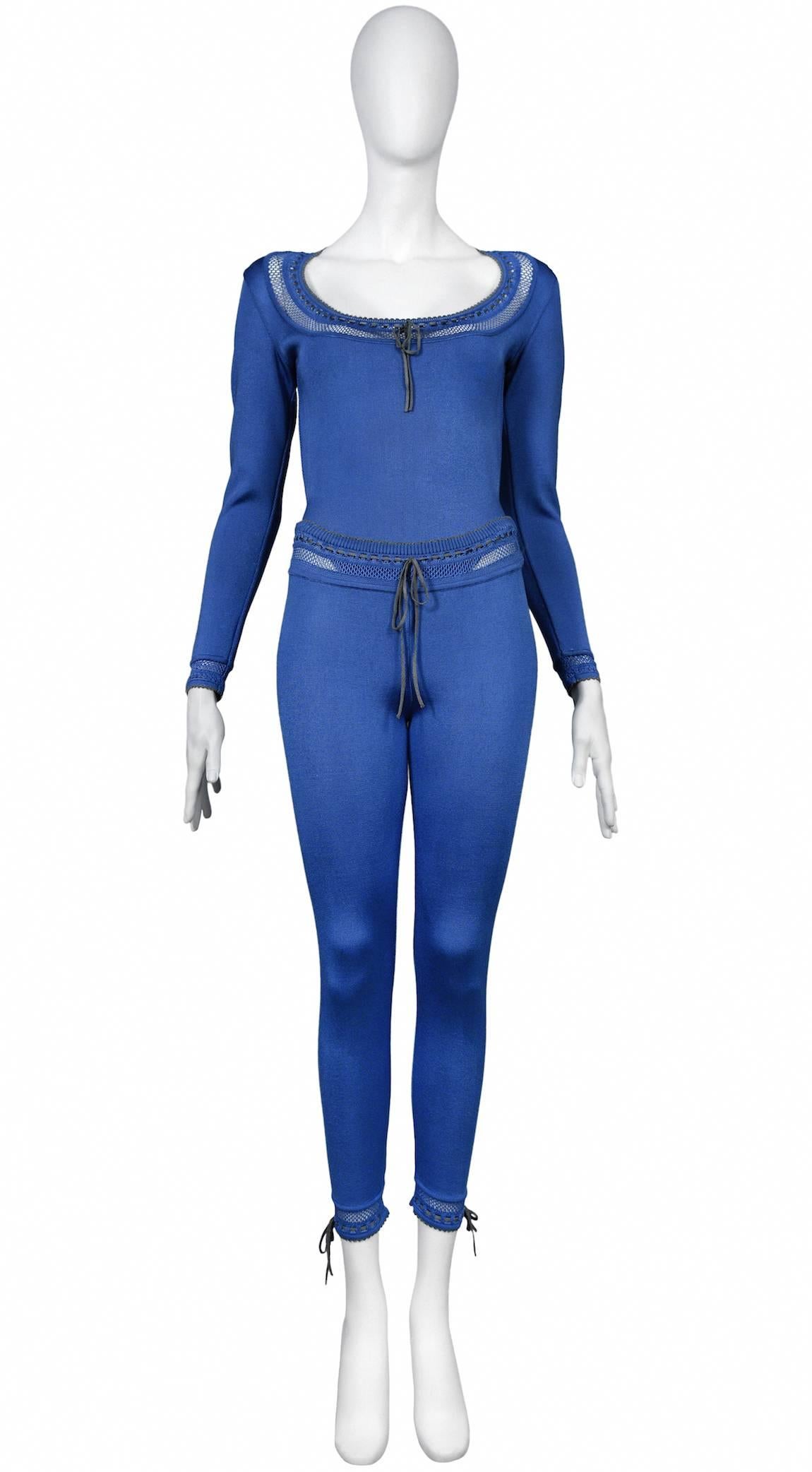 Vintage Azzedine Alaia blue rayon knit bodysuit and leggings ensemble. Ties at neckline, cuffs and waist band. Open knit lace details.