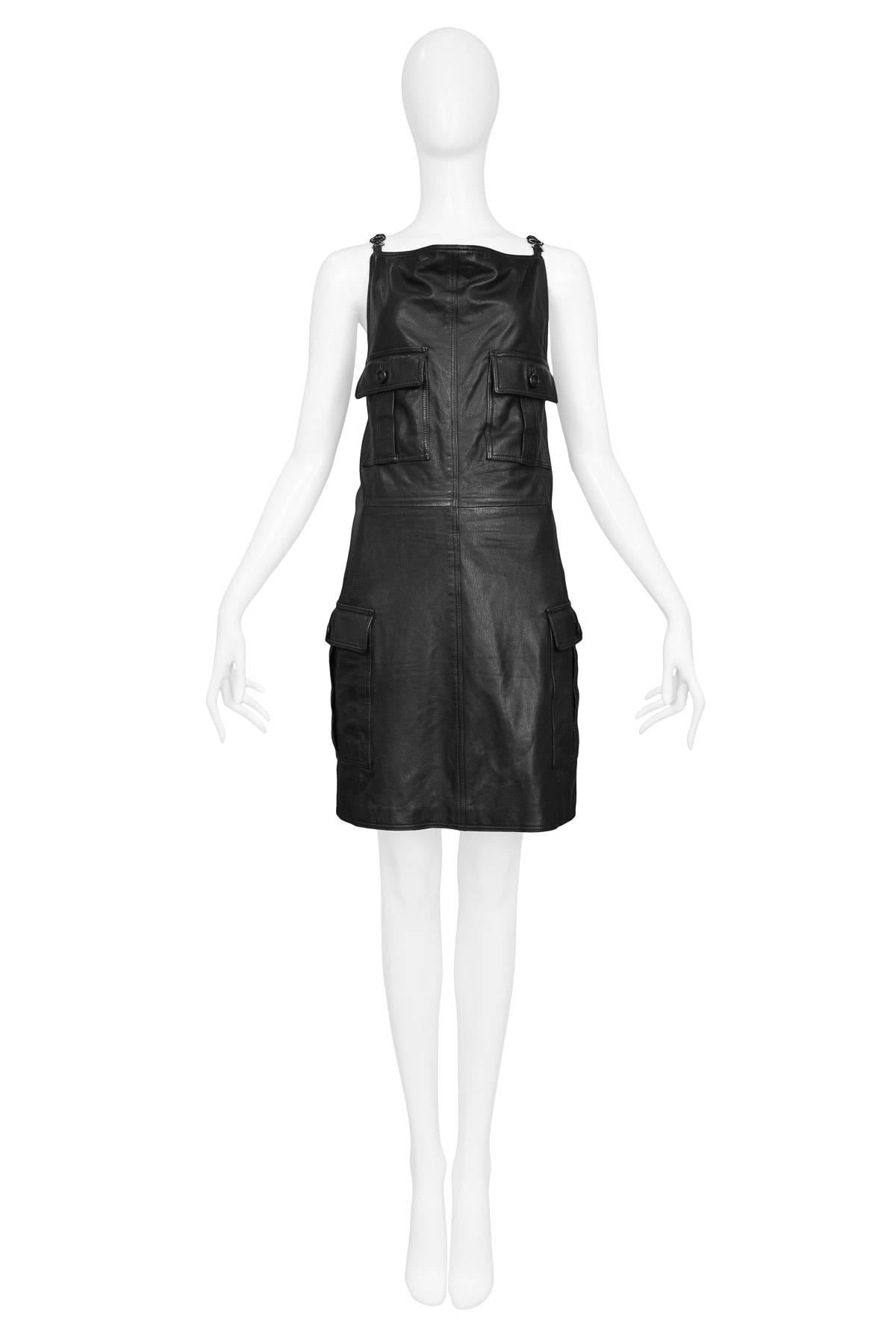 Vintage Gianni Versace black leather jumper dress with 4 patch pockets at front, rhinestone Medusa strap detail & back zip closure. Circa 1990s.

Size: 2/4