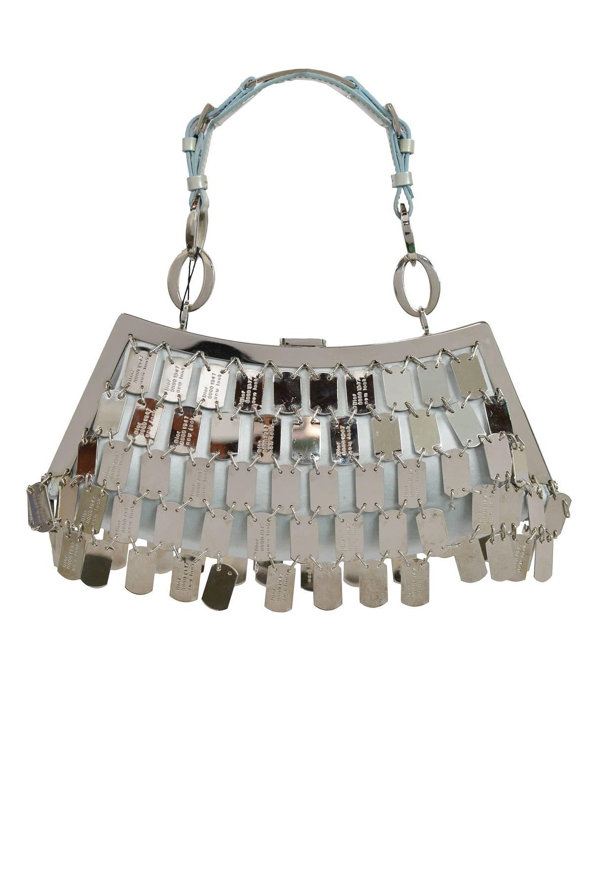 Vintage John Galliano for Christian Dior pale blue satin handbag with silver metal engraved dog tag overlay & leather handle with buckle detail. 

Excellent Condition. 