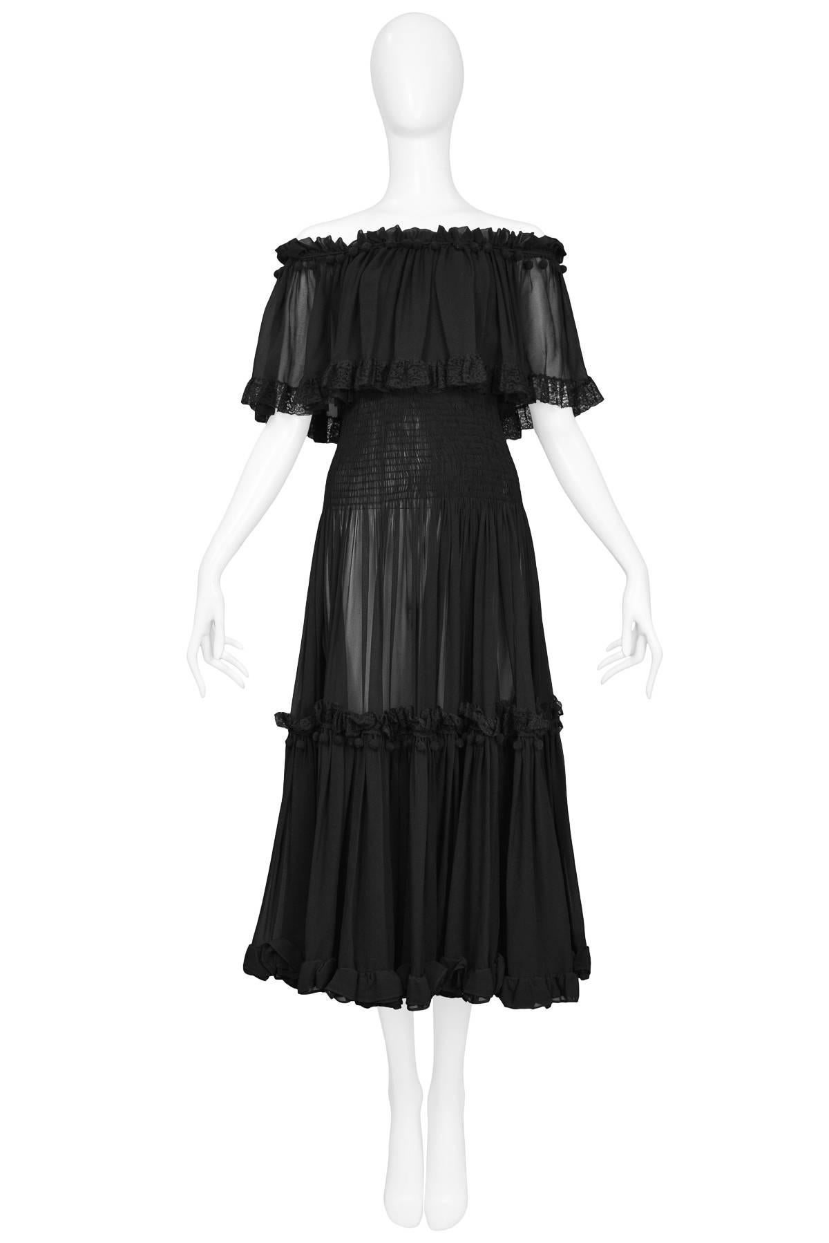Vintage 1970s Yves Saint Laurent black off the shoulder tiered gypsy dress featuring a smocked bodice and adorned with lace & pom poms.

Excellent Condition.

Size: 36/38