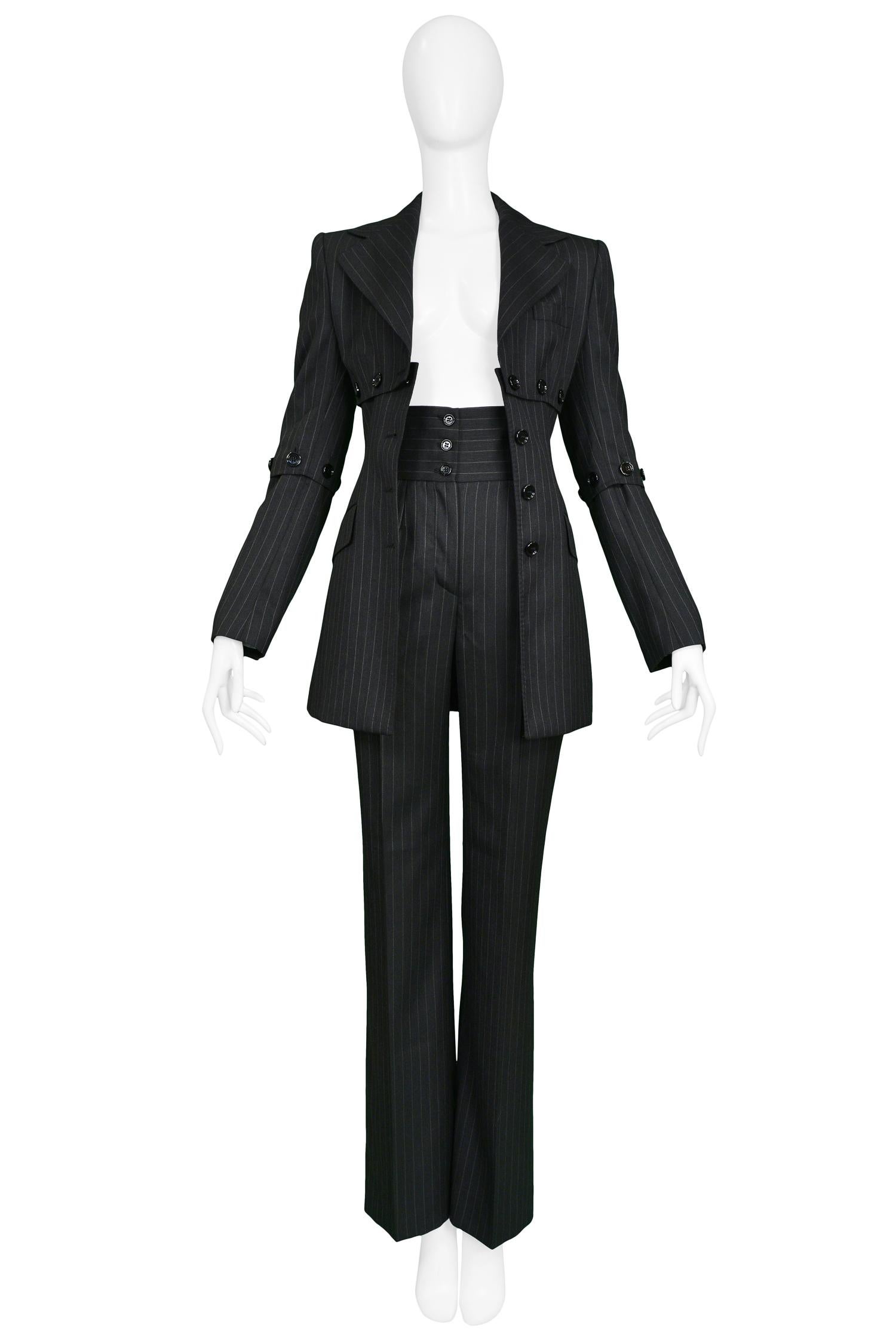 Vintage Dolce & Gabbana cashmere blend charcoal pinstripe pantsuit featuring high waisted pants with 3 button closure and button detail under chest, back & arms. 

Excellent Condition.

 Size - JACKET: 40, PANTS: 38