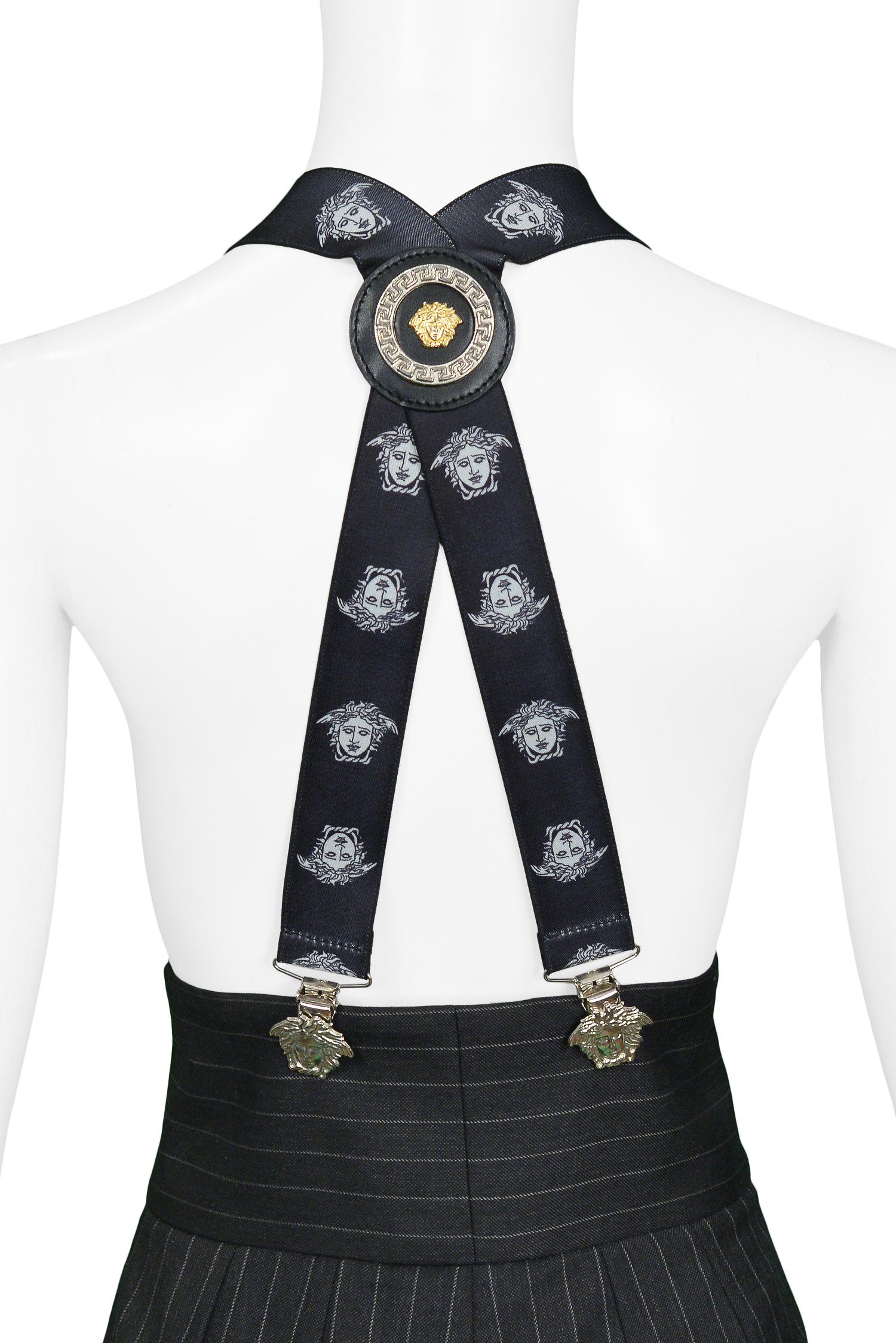 Vintage Gianni Versace black and white suspenders with printed Medusa heads, silver tone Medusa head clips, and medallion at back. Circa 1990s.

Excellent Condition.

Size: ONE SIZE
