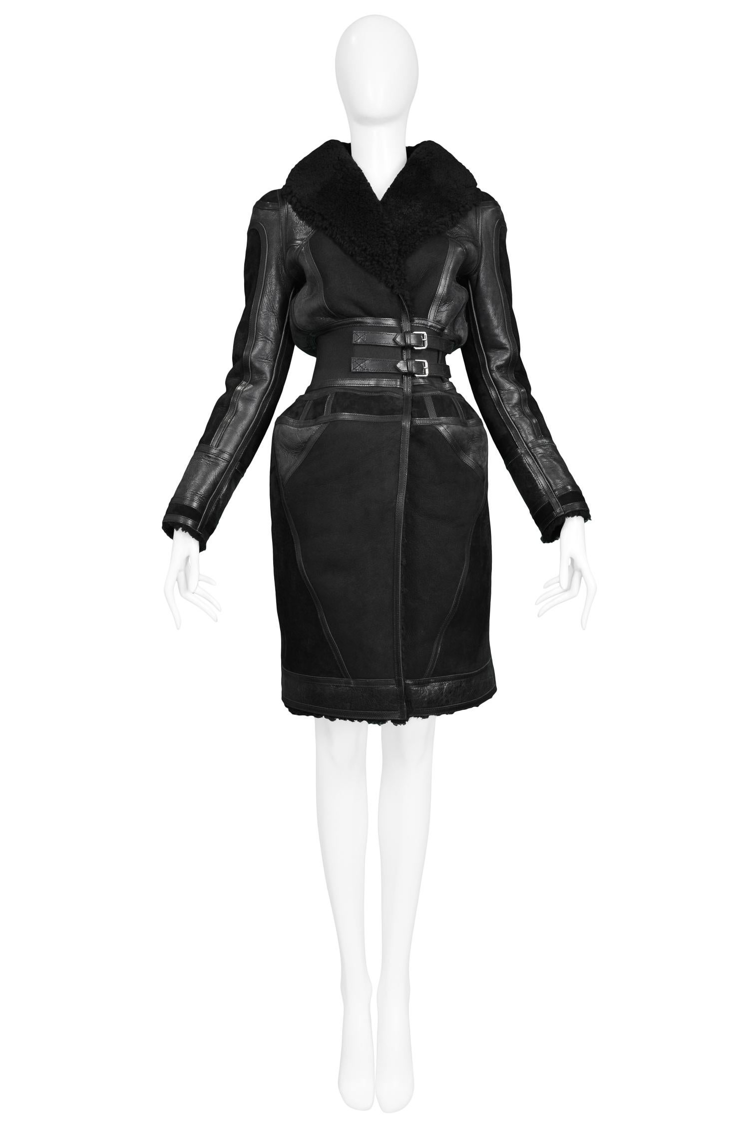 Resurrection Vintage is excited to offer a vintage Nicolas Ghesquière for Balenciaga black suede corset coat featuring black tonal leather panels, shearling collar and lining, an elastic waist with double belted detail and an exaggerated