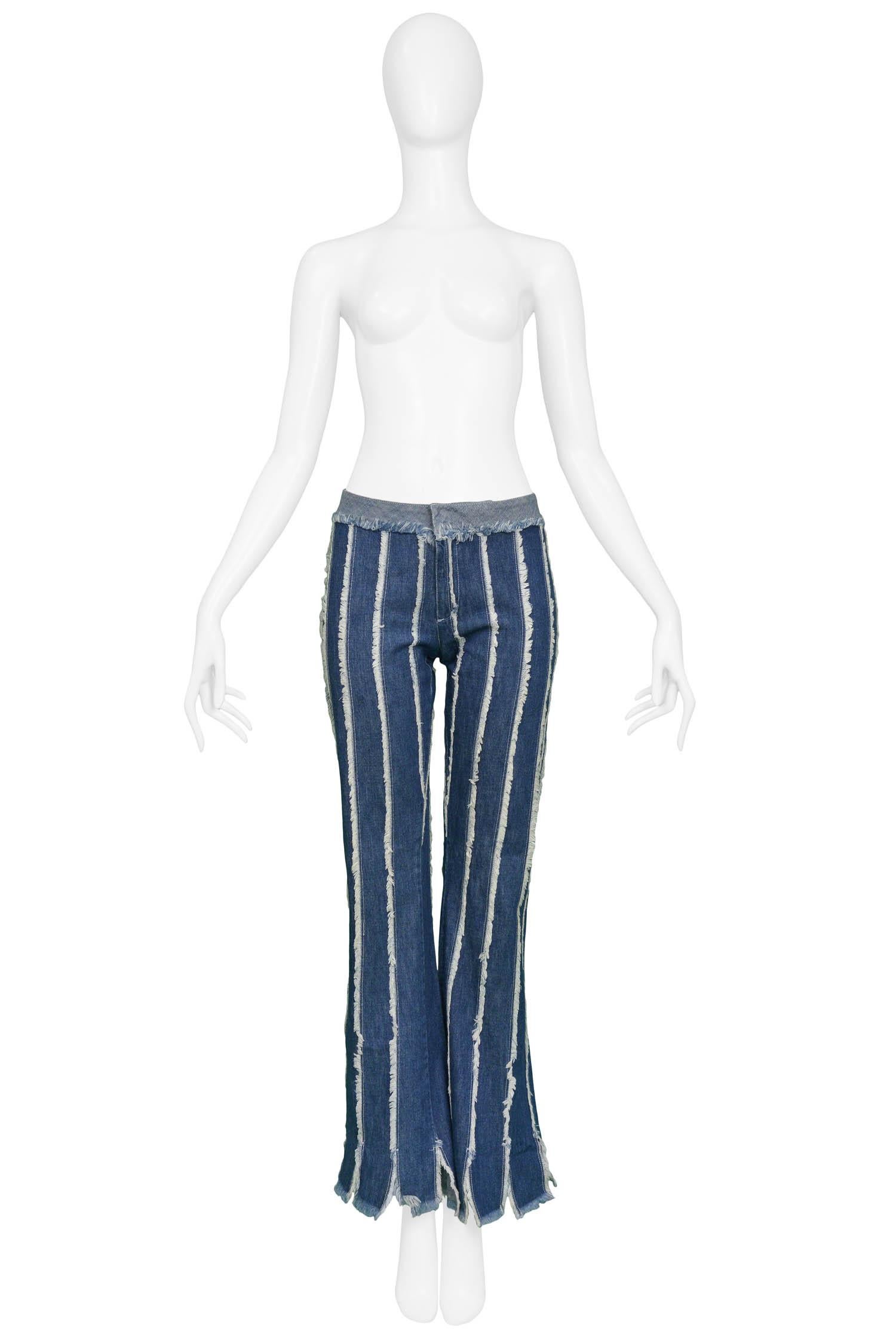 Vintage Jean Paul Gaultier blue denim flare leg pants featuring vertical frayed stripe detail and carwash hem. 

Excellent Condition.

Size: 42