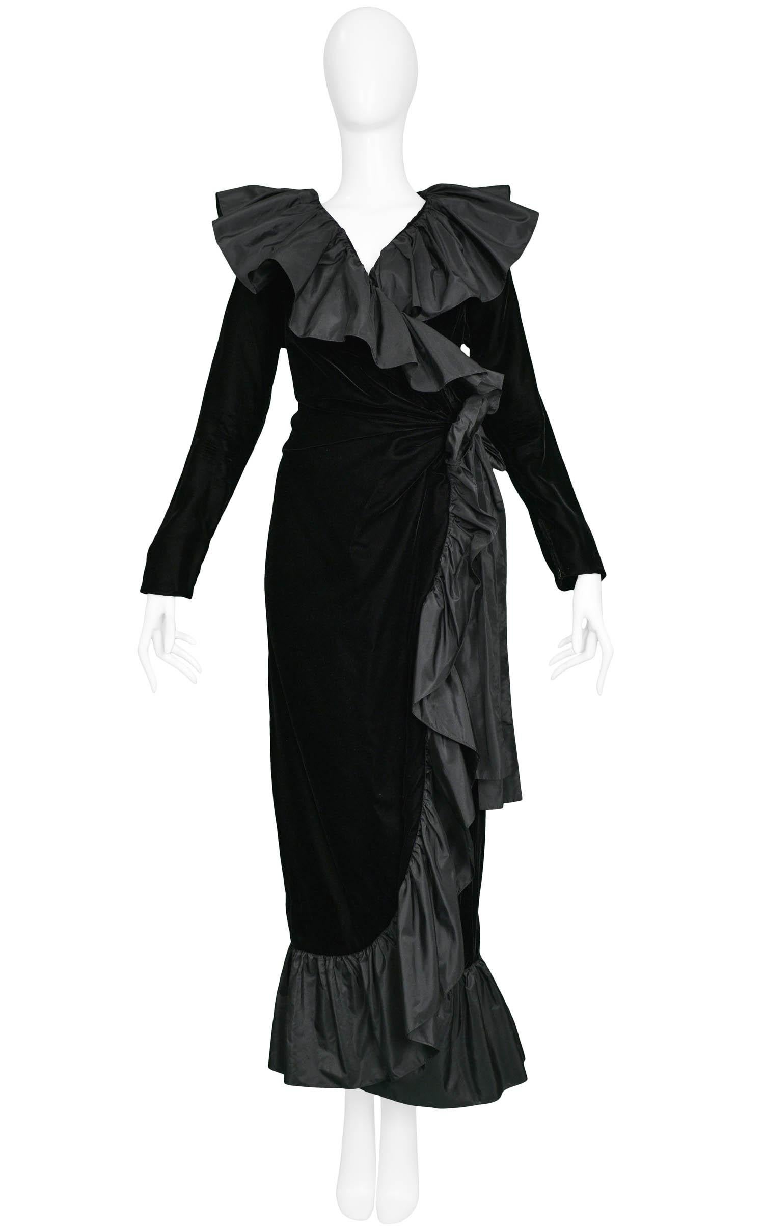 Vintage Yves Saint Laurent black velvet wrap gown with long sleeves & tonal black metallic taffeta ruffle trim, collar and sash at side.

Excellent Condition.

Size: 40