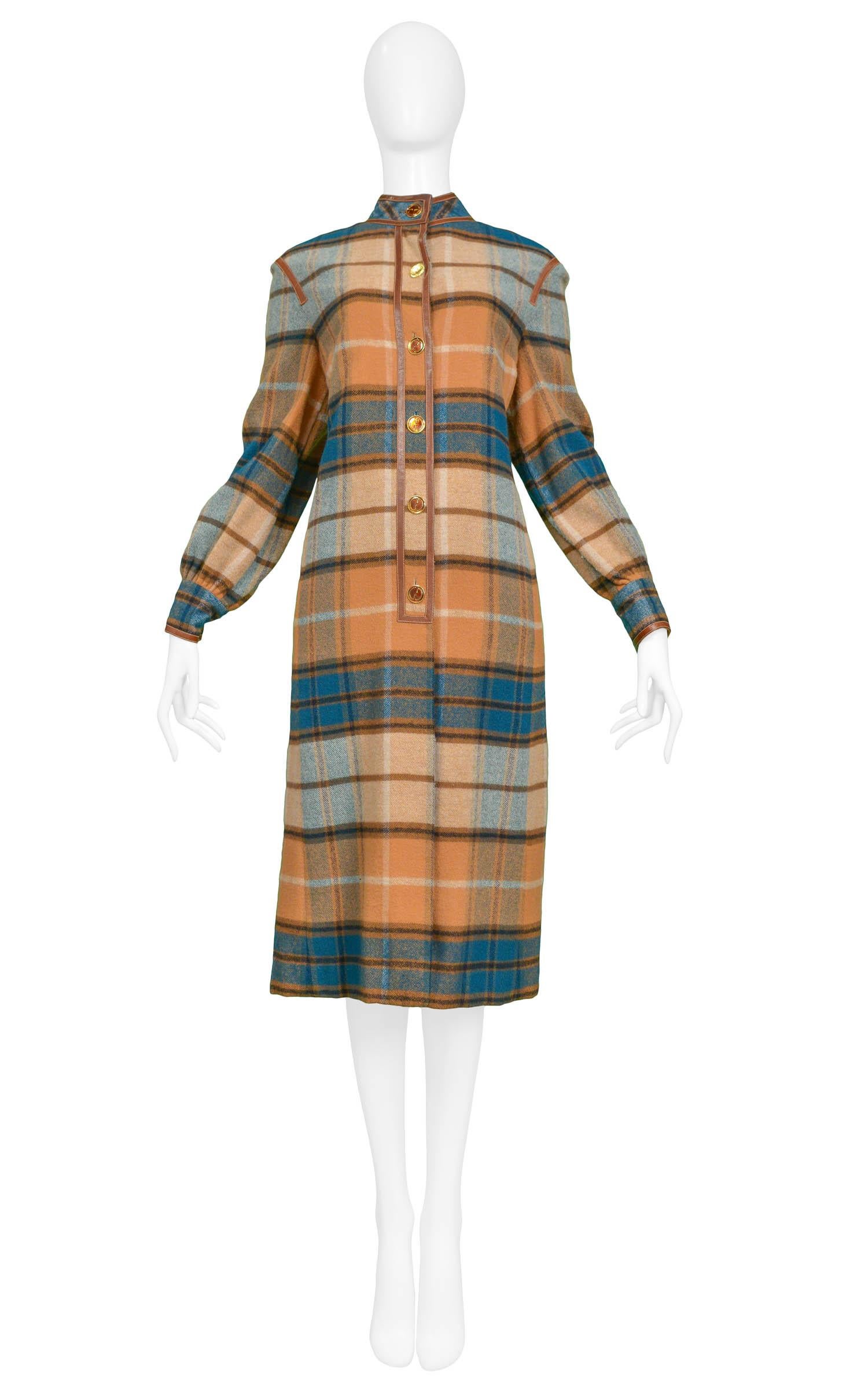 Vintage Gucci plaid wool coat dress with shades of blue & brown plaid, classic colored enamel logo buttons decorate the front placket and cuffs with leather top stitched trim detailing throughout.

Excellent Condition.

Size: Oversize & Easy Fit