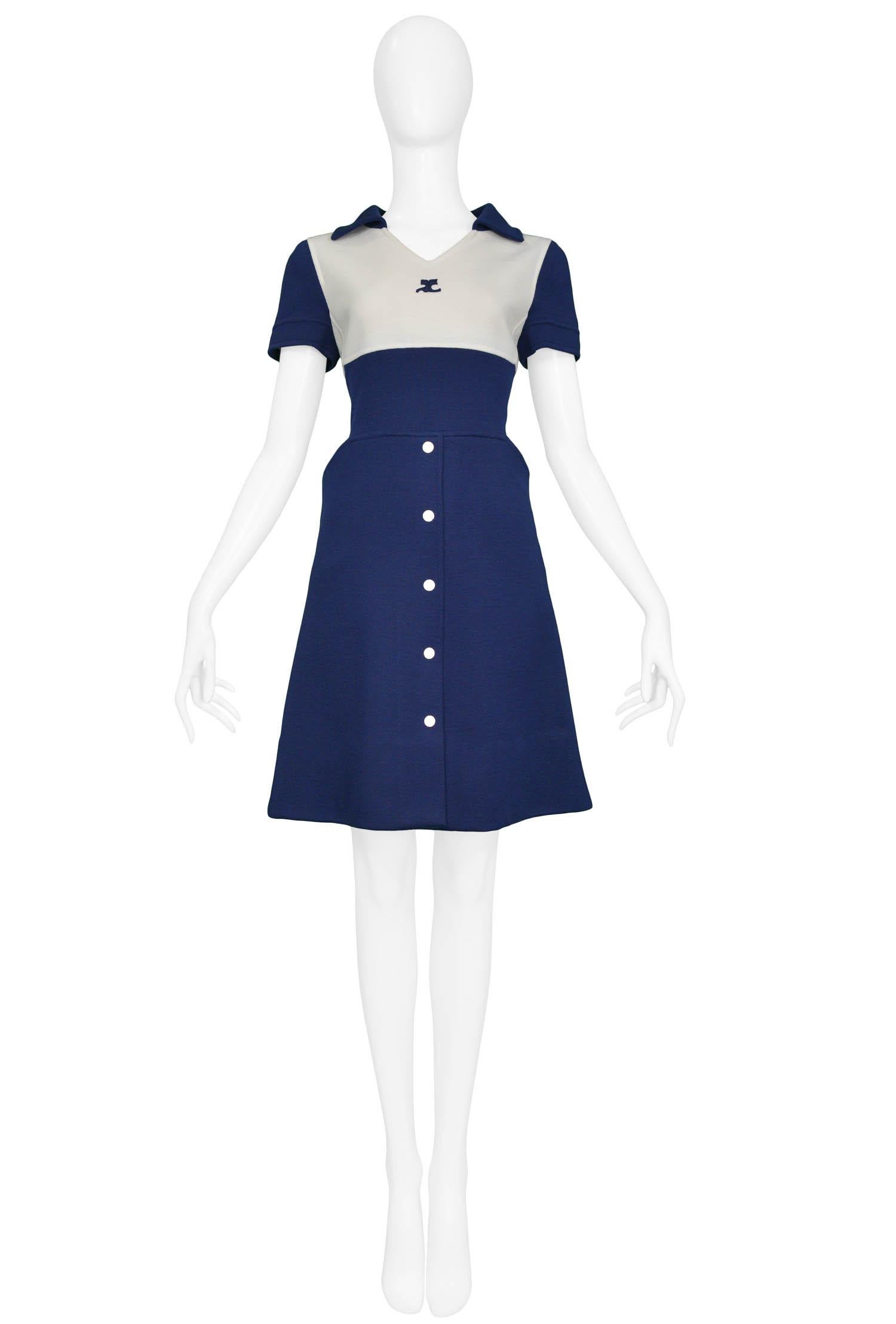Vintage André Courrèges blue short sleeve wool dress with white yoke featuring the Courrèges iconic logo at the neck and white buttons up the front of the skirt as well as along the center back of the dress.

Excellent Condition.

Size: 4 