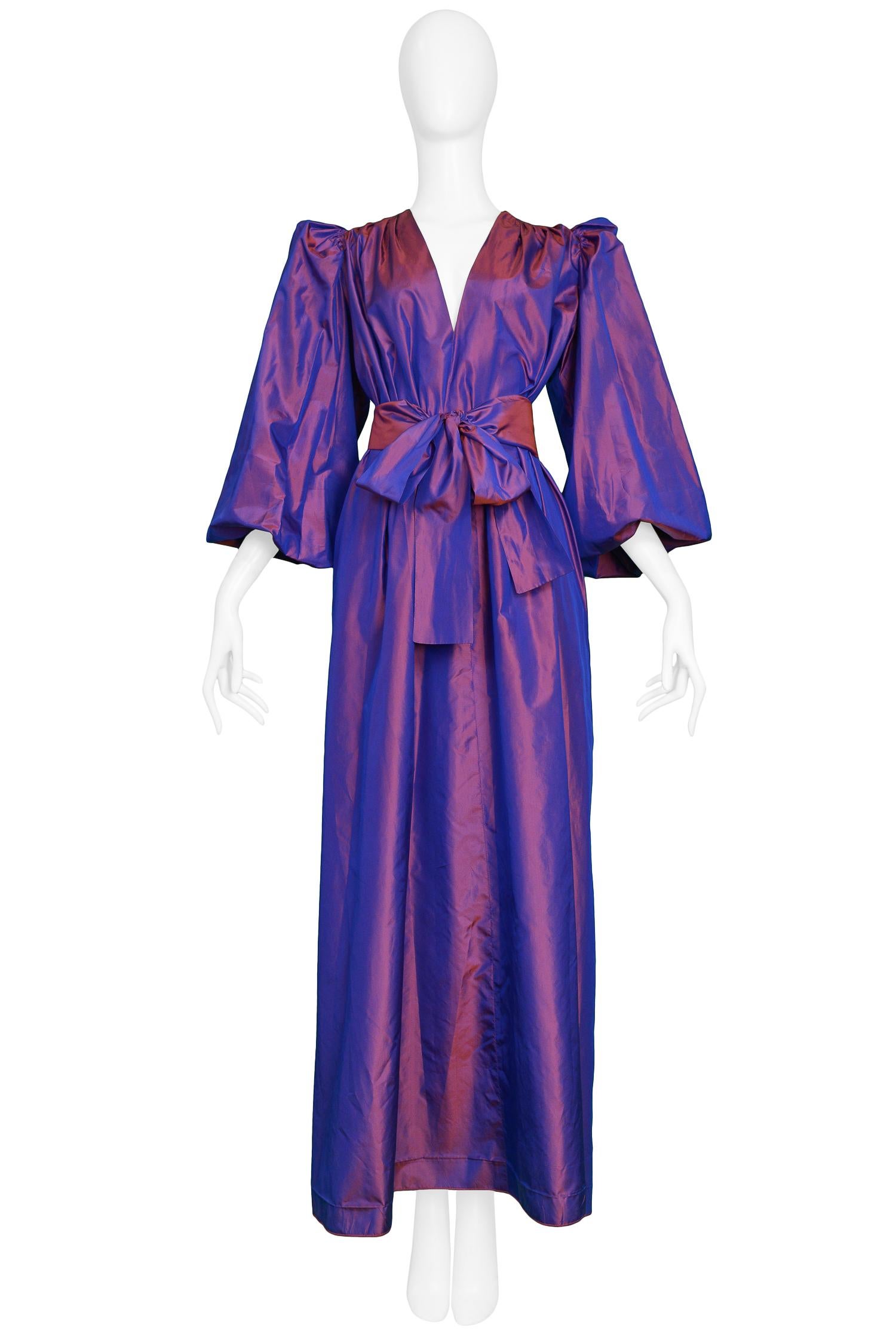 Vintage 1980s Yves Saint Laurent purple metallic taffeta gown featuring blouson sleeves with gathering at the shoulders, open neckline & sash that ties at the waist. 

Excellent Condition.

Size: 40 

