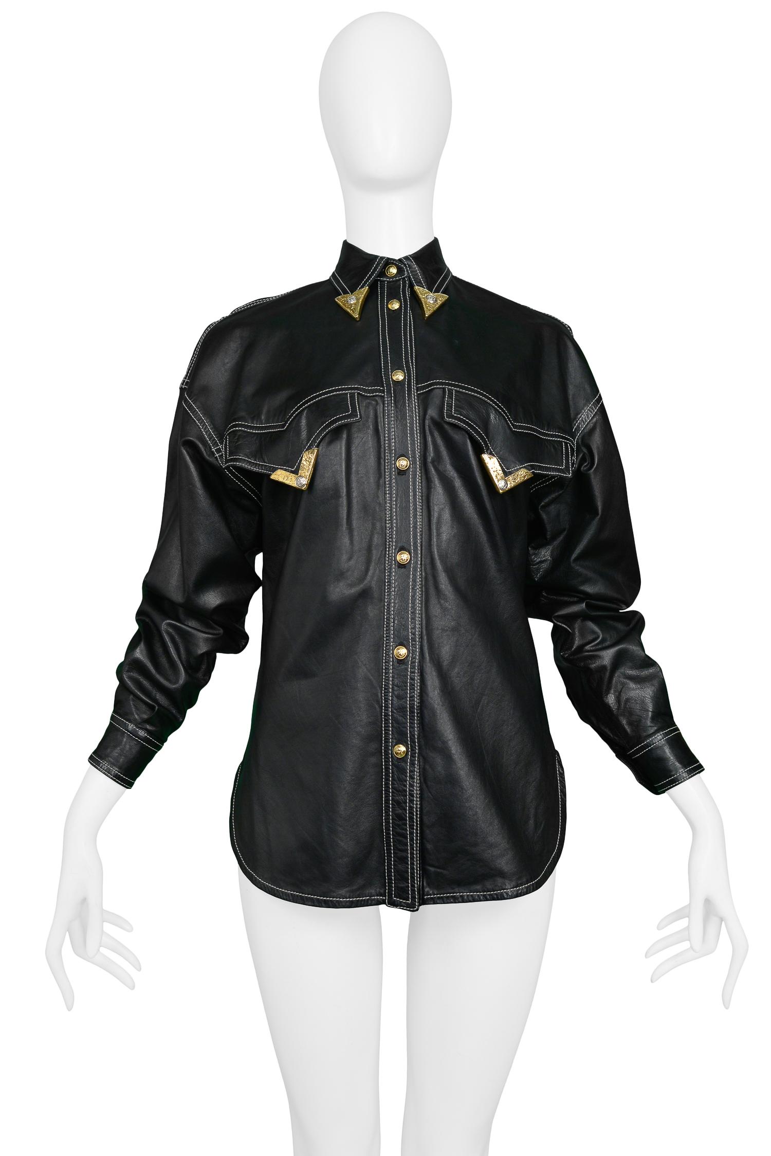 Vintage Gianni Versace black leather western shirt featuring a gold tipped collar and chest pockets, exposed white stitching and Medusa snap buttons at front closure. 

Excellent Condition.

Size: 40