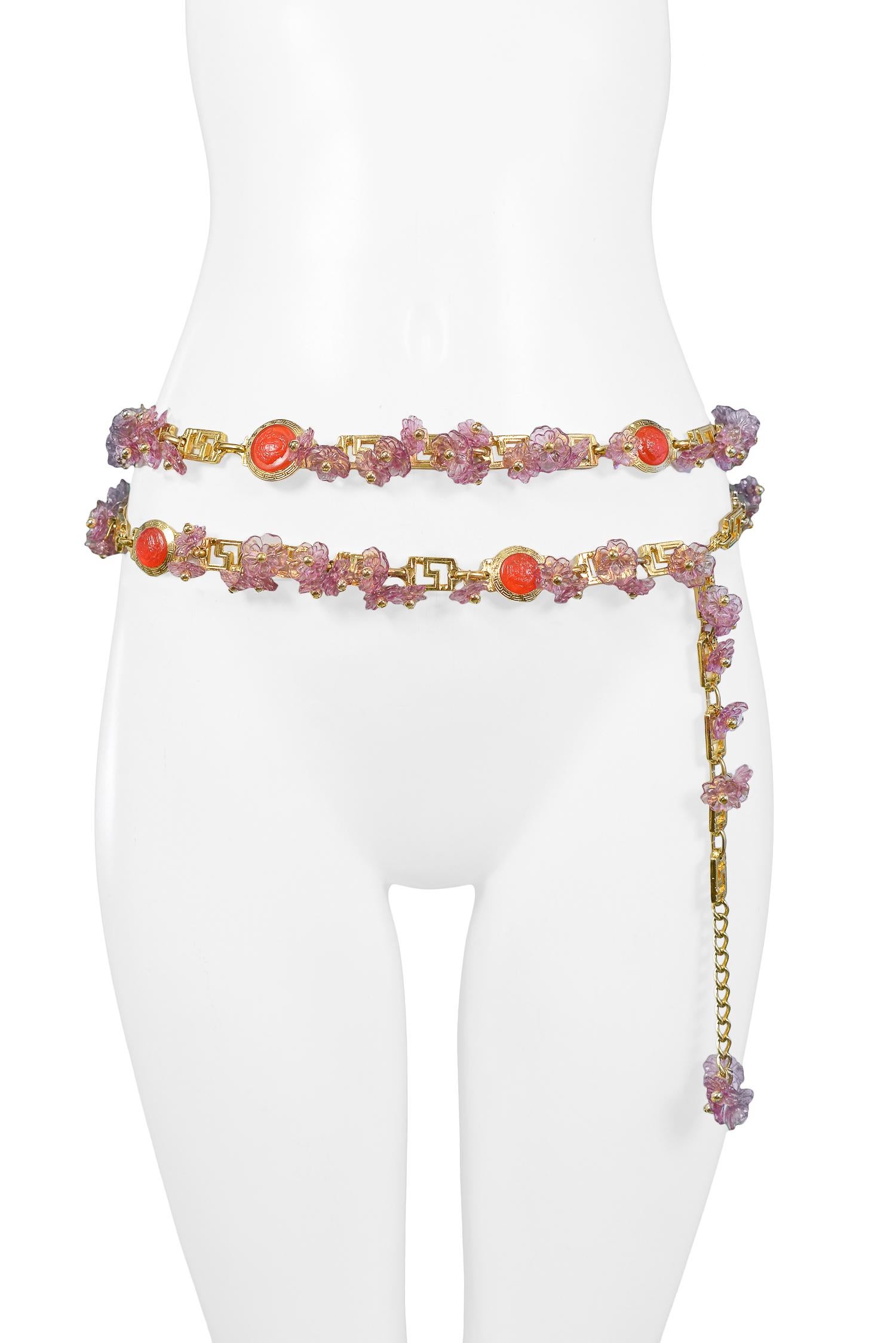 Vintage Gianni Versace lavender acrylic floral charm belt with gold beads, red Medusa medallions, and greco links. Circa, 1993.

Excellent Condition.

Size: ONE SIZE