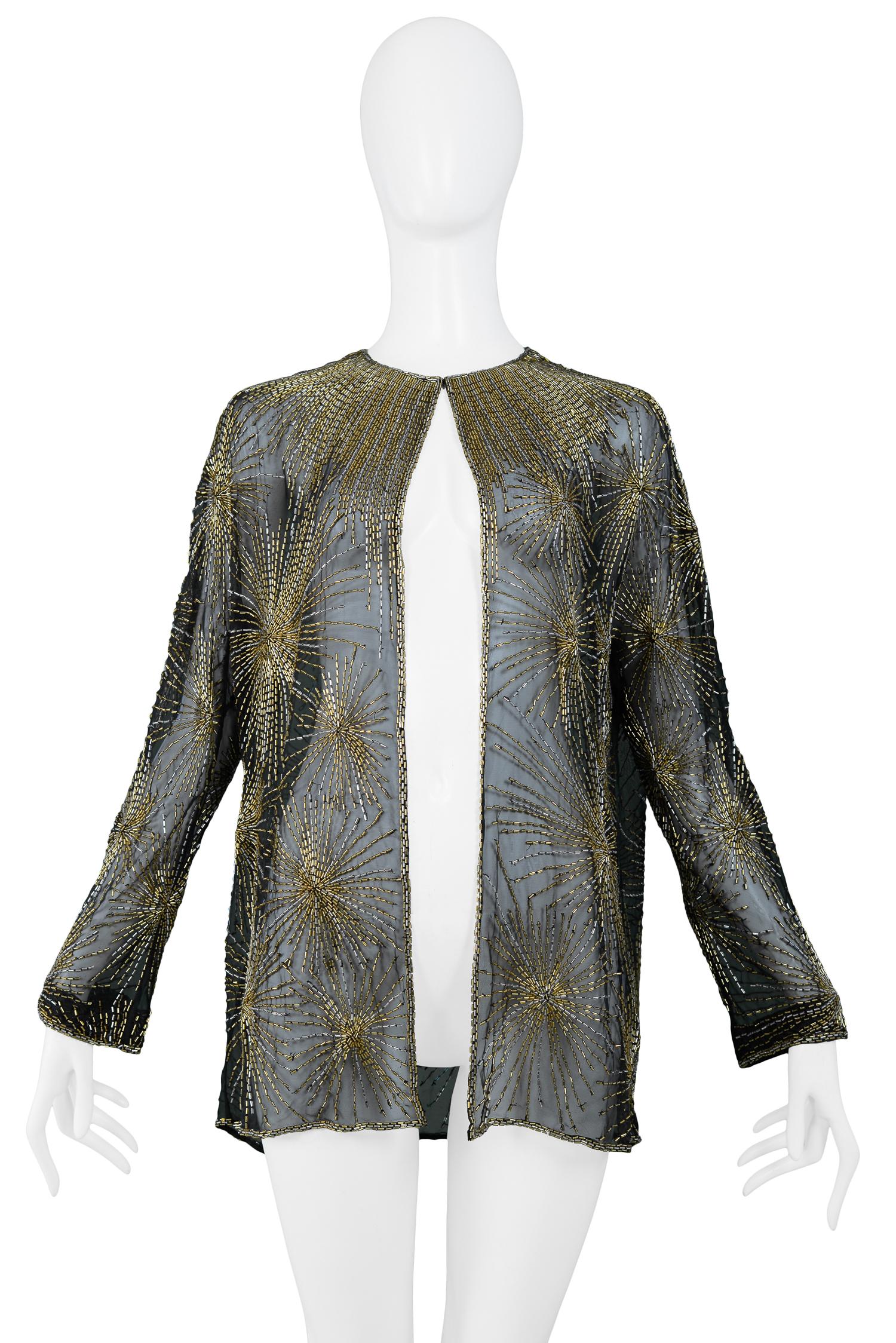 Vintage Halston black chiffon long sleeve evening jacket featuring allover gold and silver beaded firework bursts, a cascade of beads at the neckline and double beaded trim along the opening and hemline. Single hook & eye closure at neck. From the
