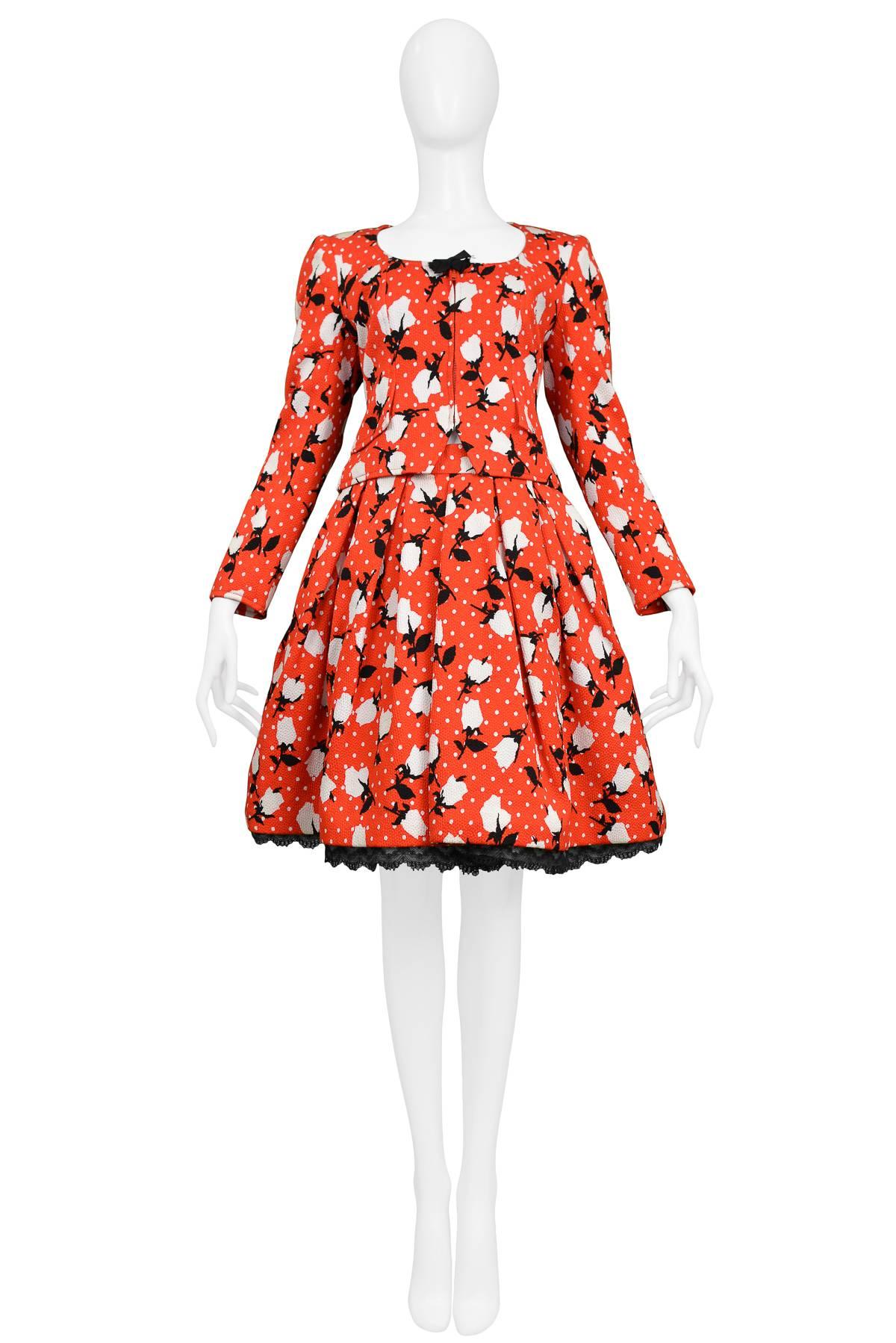 Vintage Christian Lacroix red floral ensemble featuring a matching jacket and skirt. The zip front fitted jacket is made out of an all over red, white and black floral and dot print textured cotton blend fabric and features peplum detailing at the