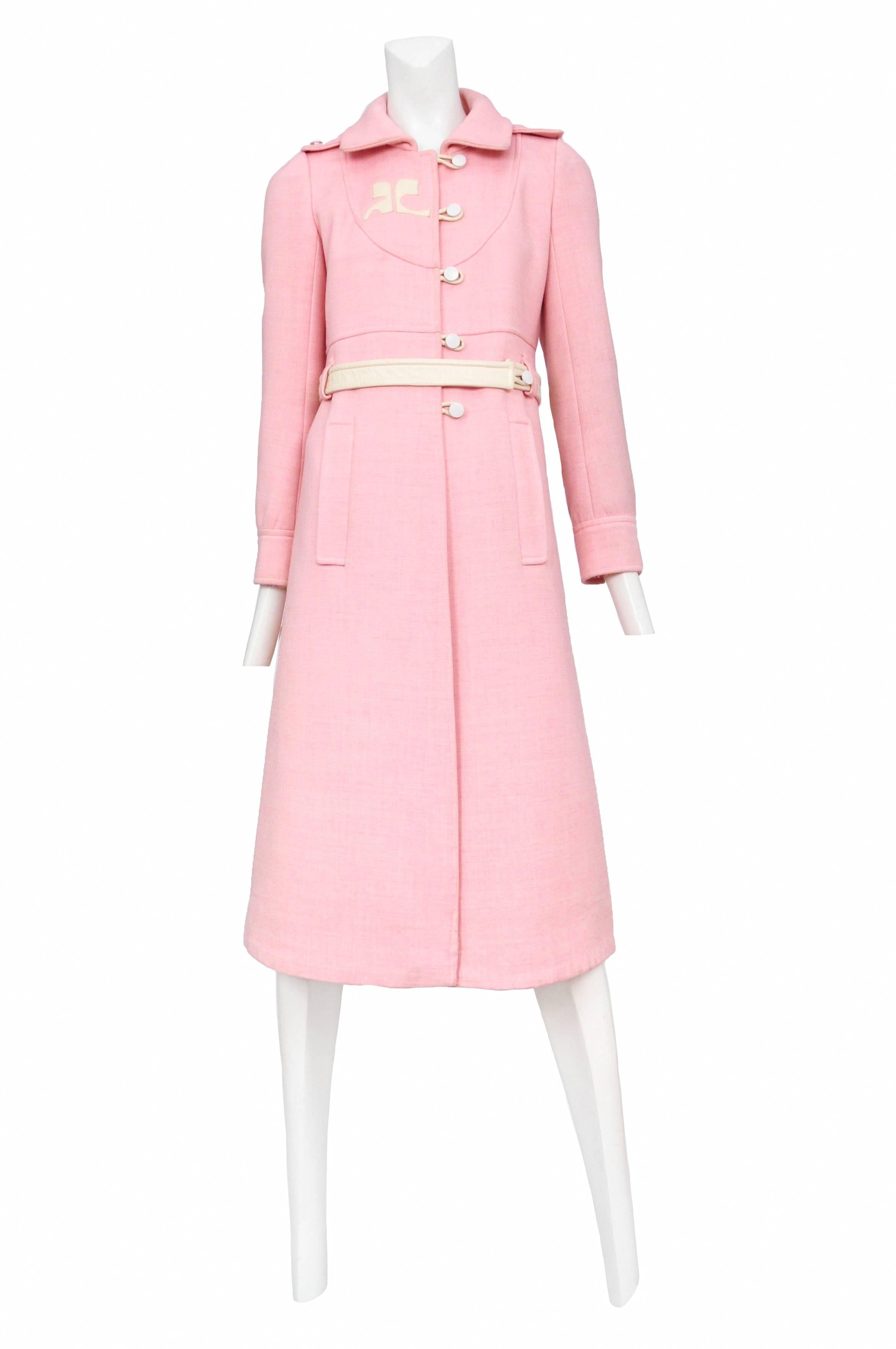 Soft pink wool coat with white vinyl buttons and belt with white vinyl Courreges logo at shoulder. Beautiful detailing throughout. Courreges size 0