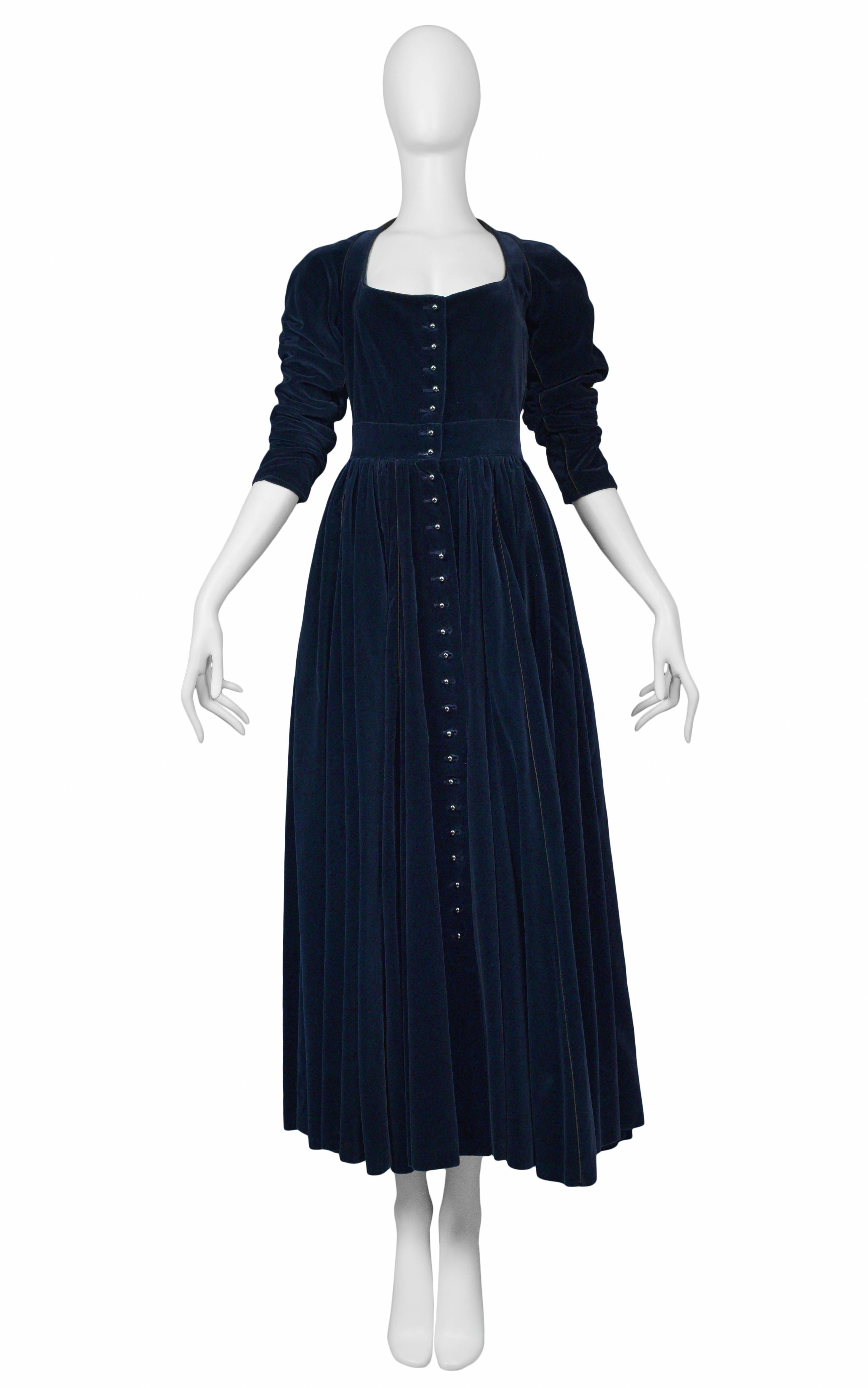 Vintage Azzedine Alaia navy blue velvet button front jacket-style gown featuring a fitted bodice and gathering at waist. Circa 1986.

Excellent Condition.

Size 38

Measurements:
Bust 38