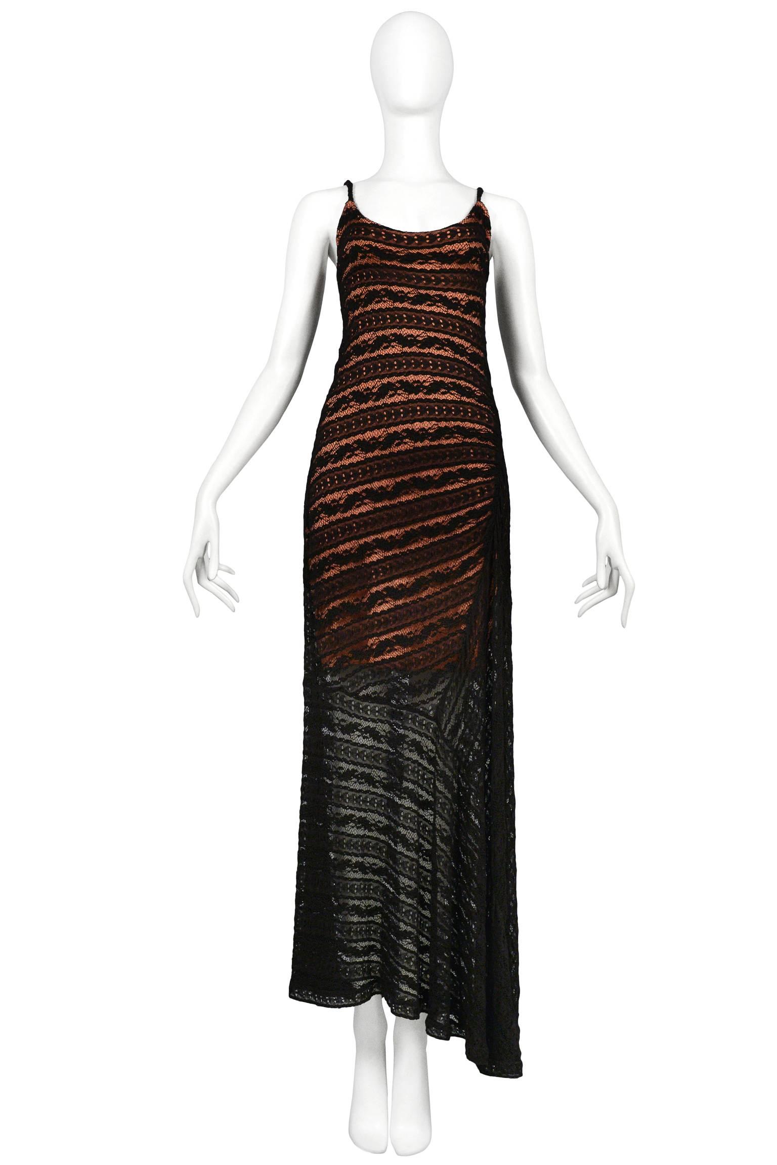 Vintage Azzedine Alaia black lace spaghetti strap dress with built in pink slip dress and bias drape at the hip. Dress features asymmetrical hem.  Circa 1993.