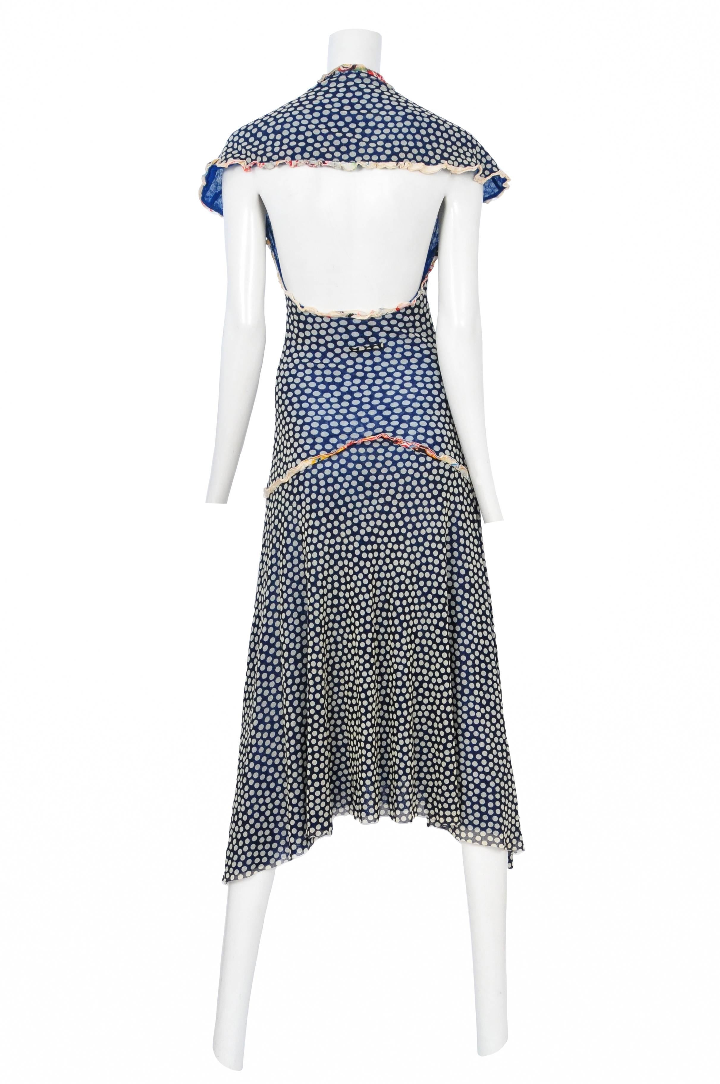 Vintage Jean Paul Gaultier v-neck blue dot pattern mesh dress featuring cap sleeves, a built in drop waist, an uneven hem line and an open back with a built in capelet at the back shoulders.