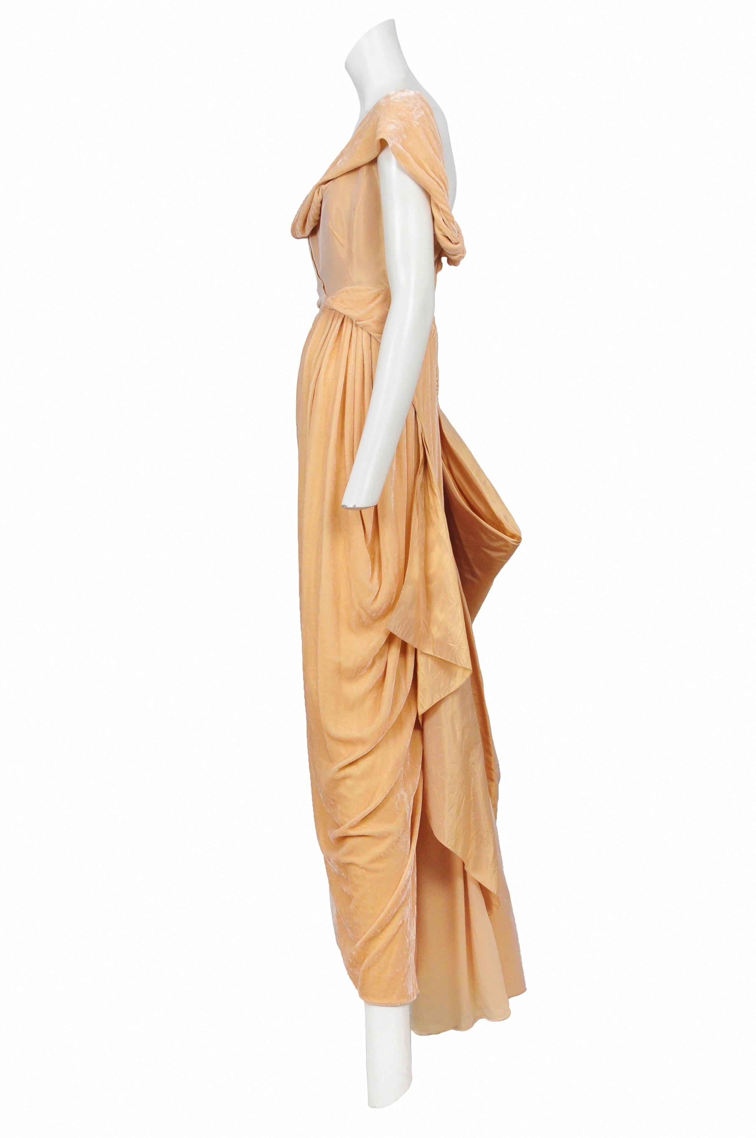 Vintage John Galliano peach iridescent taffeta and velvet drape gown featuring an asymmetrical cowl neckline, velvet drapery at hip and a covered button closure along the side.