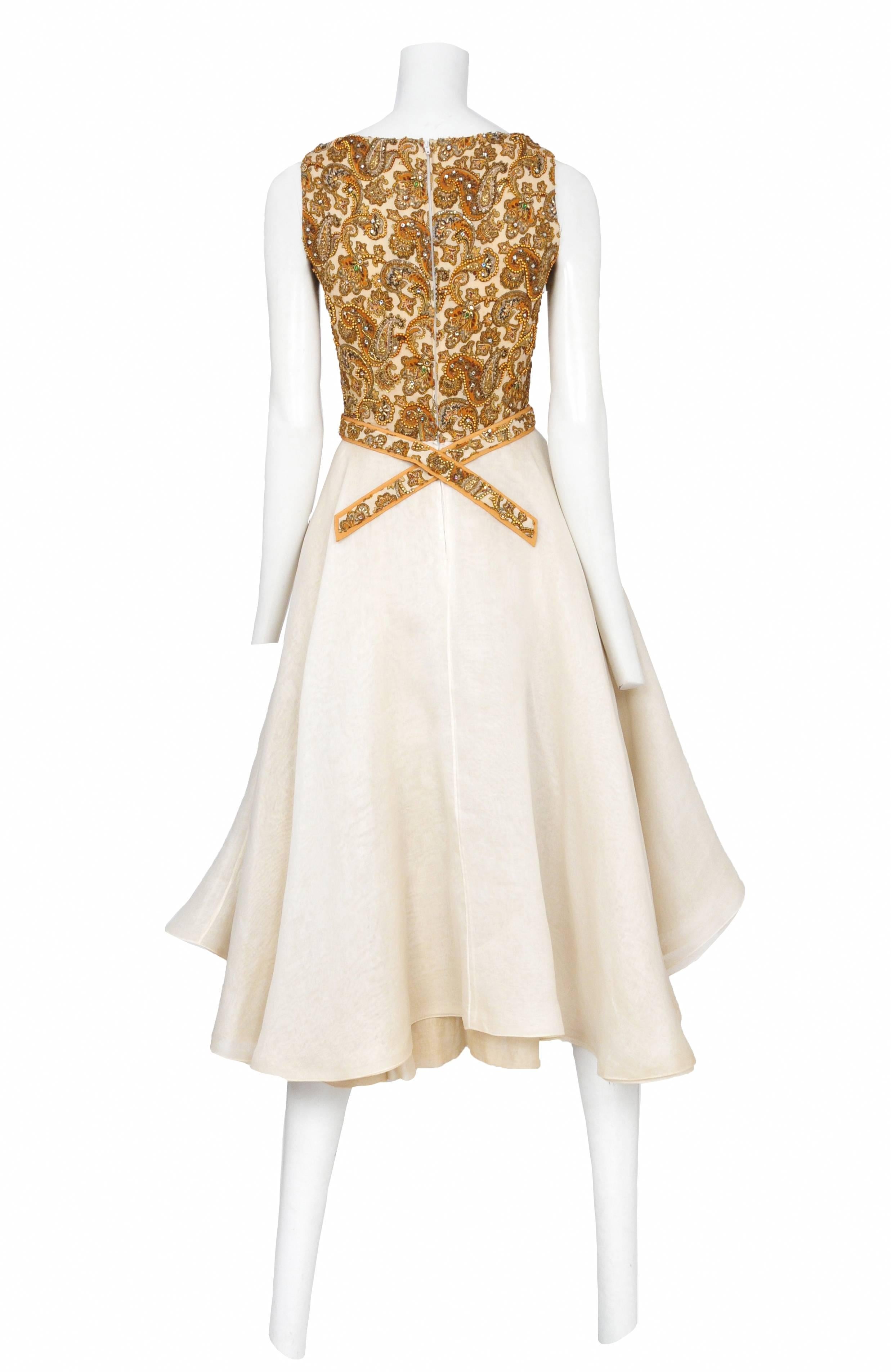 Vintage James Galanos sleeveless v-neck cocktail dress featuring a beaded paisley bodice attached to a natural color circle skirt.