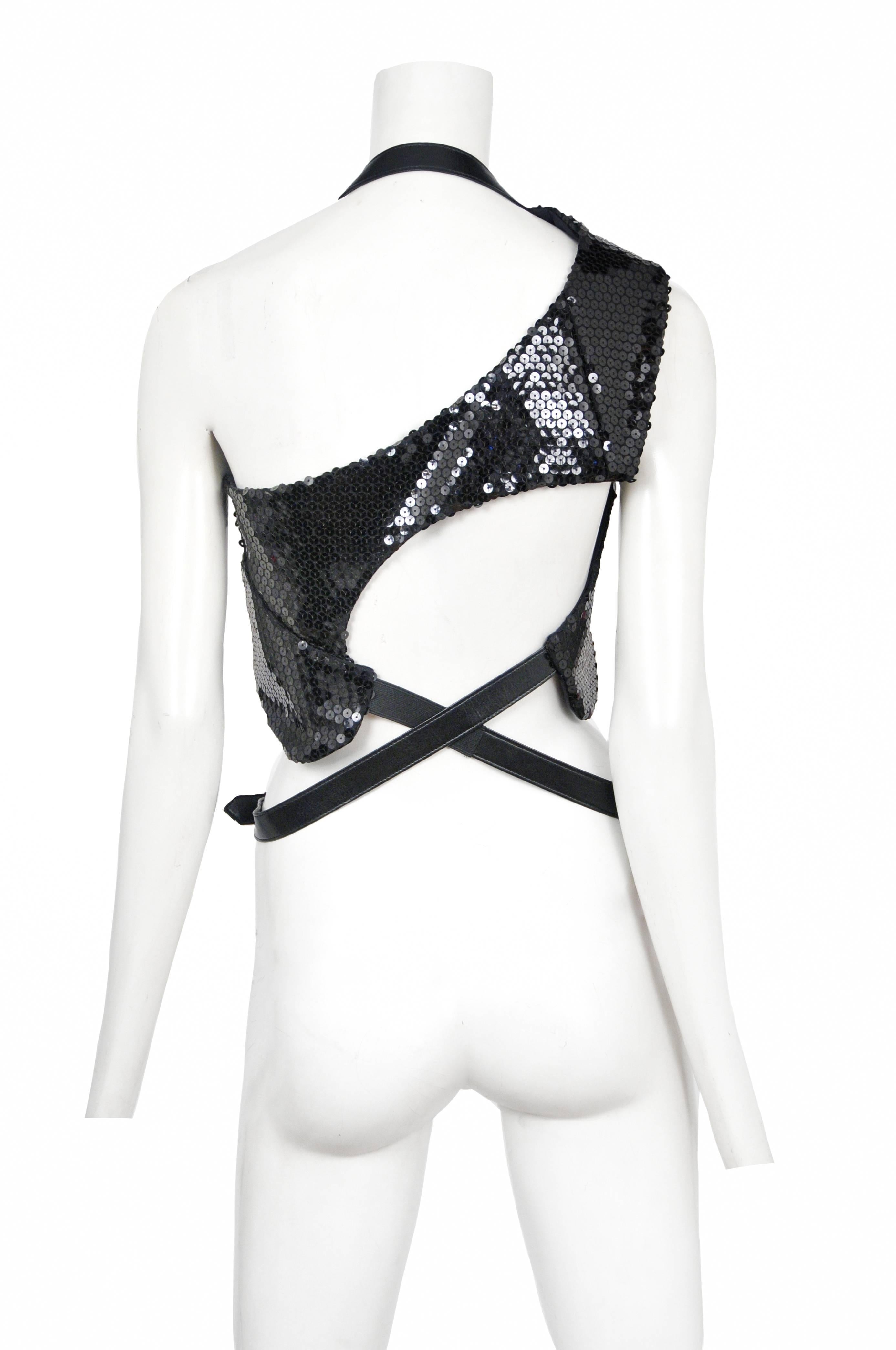 Vintage Comme des Garcons black sequin harness vest featuring an attached black belt that sits at the waist. Circa 2009.