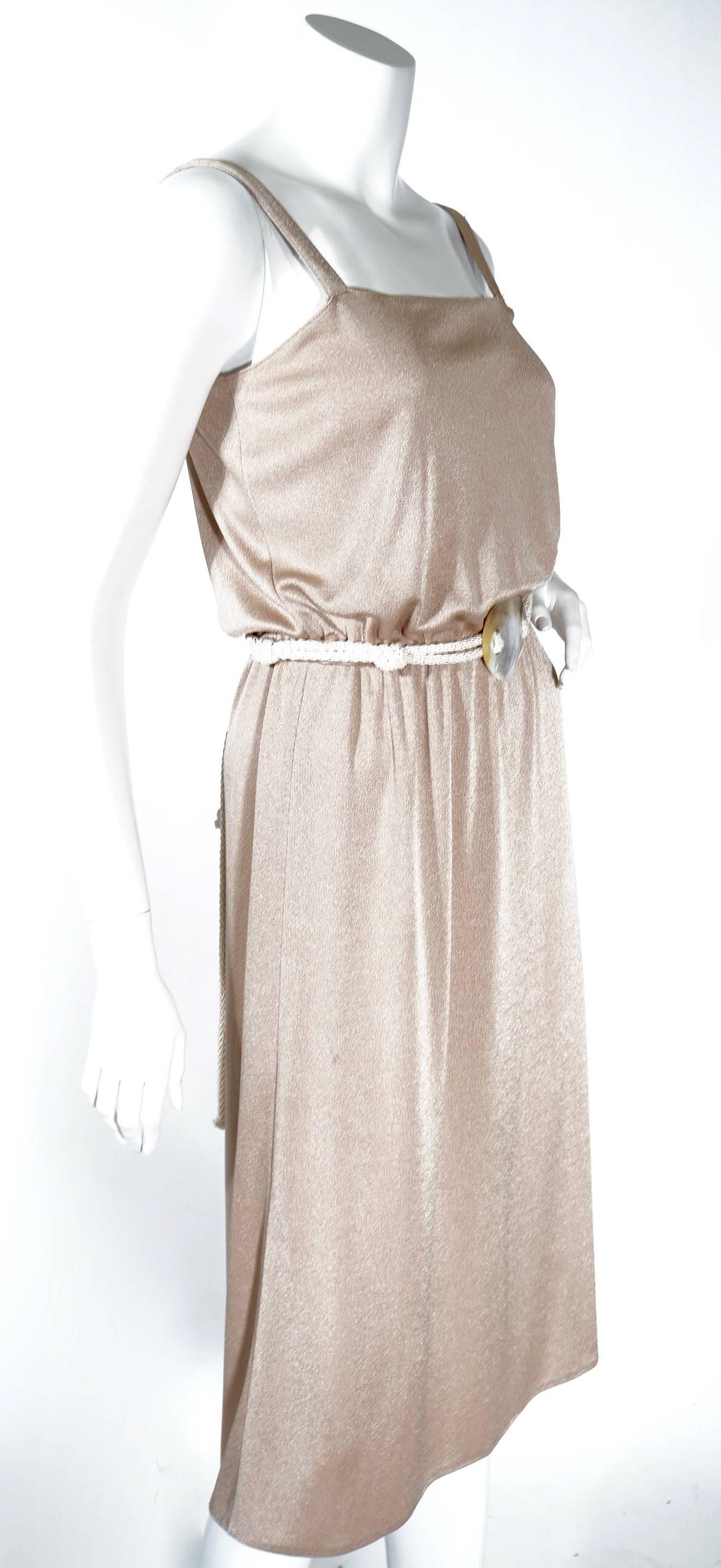 1970s beige grecian style dress. This dress features a rope style belt with a shell centerpiece. This pieces is right on trend and perfect for spring/summer 16'. Very authentic and wearable/ Very good condition.

Zip back, elastic waist band 22in-