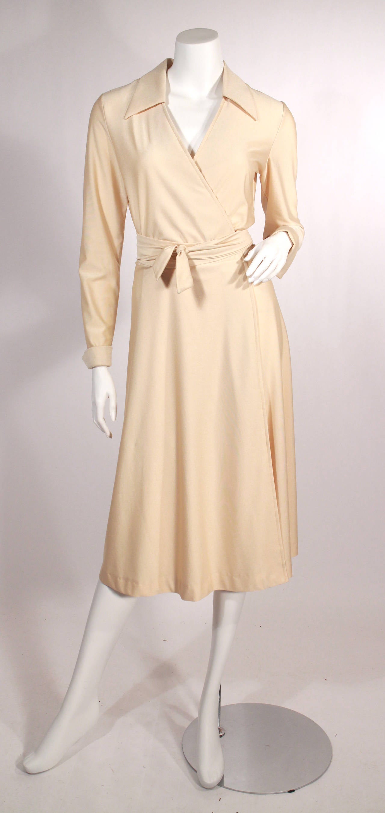 1970's Lanvin off white wrap dress. With collar, and cuffs. This dress is very wearable and beautifully timeless. Marked as size 14, fits Small-Medium, adjustable via wrap.