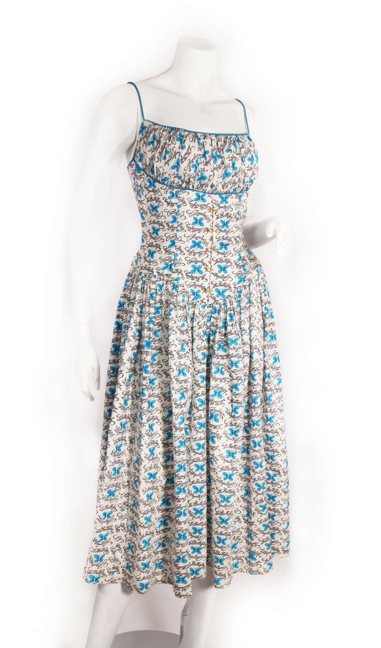 1950s adorable full skirt dress. Featuring a corset style bodice with gold clasps. Very flattering fit and super fun print for the spring and summer!