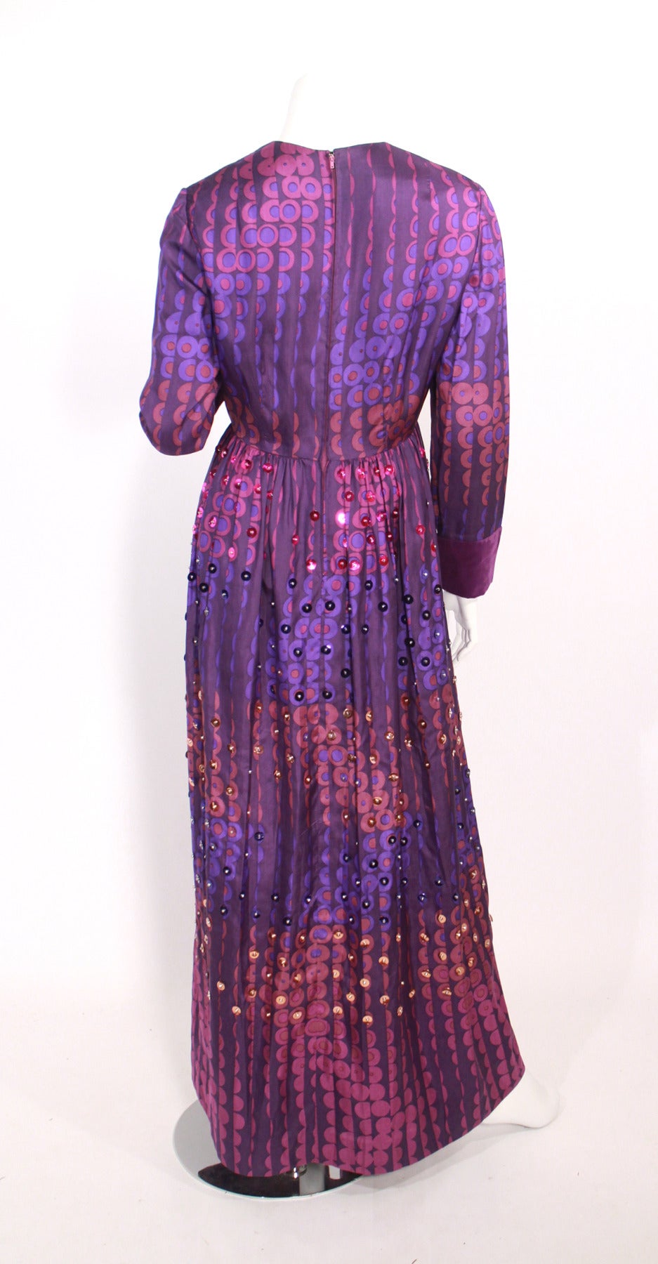 Gino Charles a division of Malcolm Starr late 1960's evening gown.

Very cool print with multi colored sequin's and beaded embellishment through out the skirt. Gathered waist, velvet purple cuffs.

Fully lined, Excellent condition.