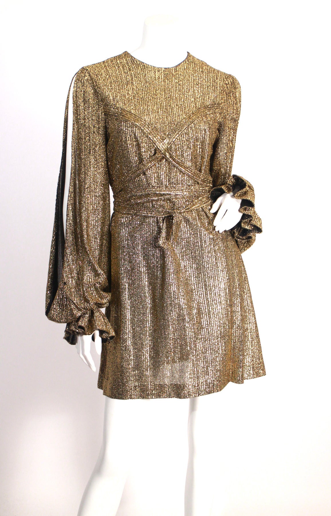 Paraphernalia for Betsey Johnson very rare gold lame mini dress. Features grecian style criss cross and open sleeves. Very good condition, super fun piece!

Size Small (2-4)

Circa late 1960s.