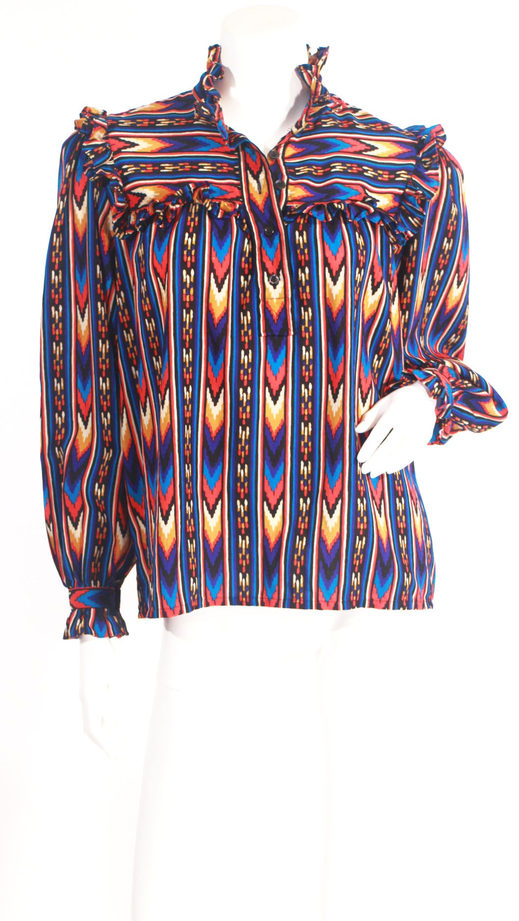 Super cool vintage 1970's YSL multi colored chevron print blouse. The print is very boho chic, perfect for the fall! Blouse features: ruffled collar, cuffs, four buttons, and neck tie. The neck tie can be worn at the neck, waist, or even