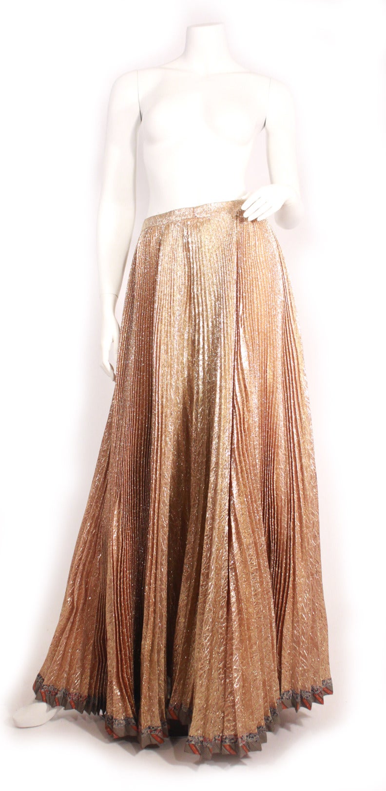 Vintage late 70s Koos show stopper full length gold lame skirt. Zip back, accordion style pleating, koos print trim bottom of skirt. 

Mint condition! Fits size US 4