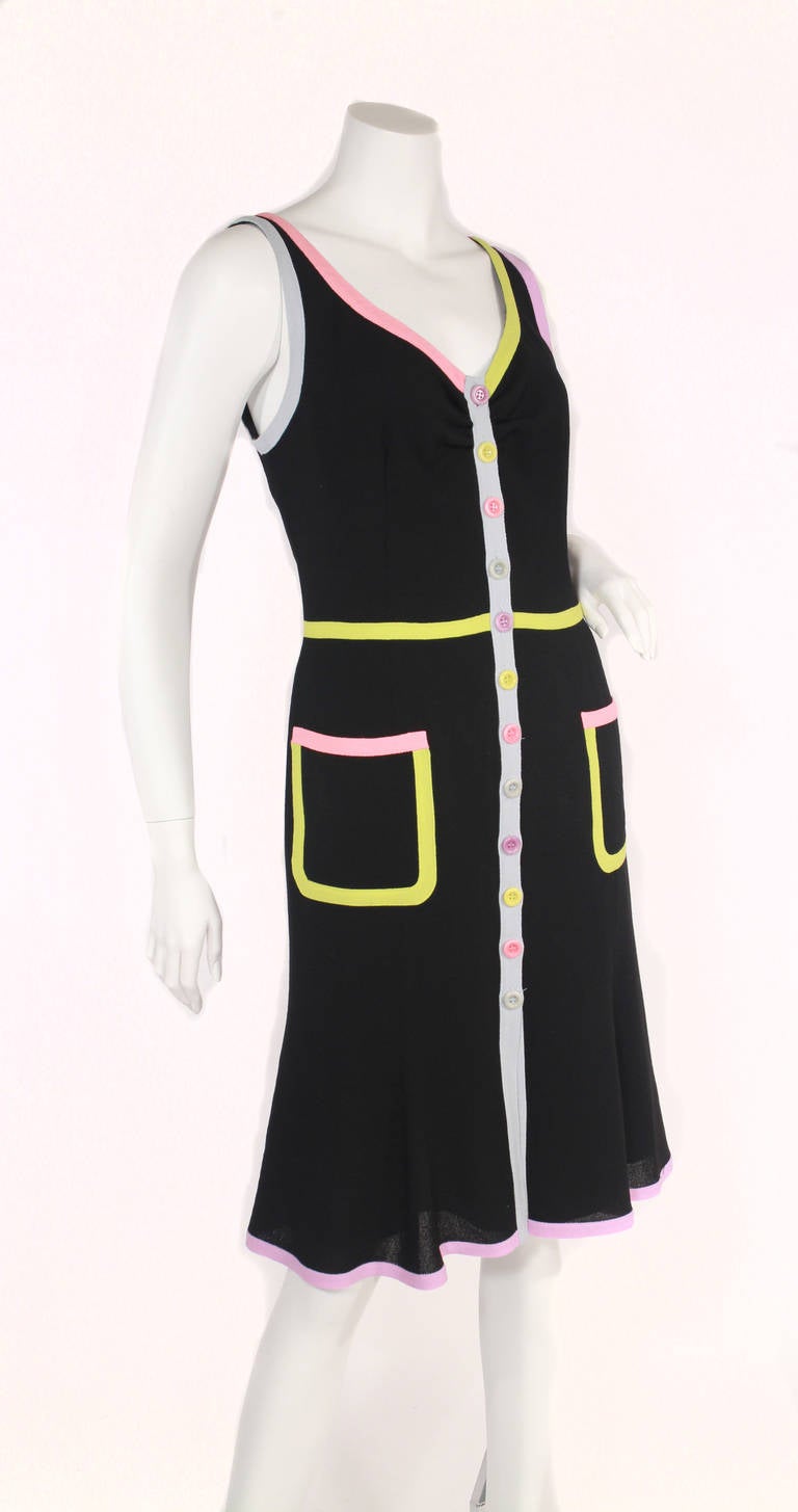 Vintage Moschino black knit dress with multi color trim and pockets. Multi colored buttons down the dress. An easy day to night dress, lovely fit and look! Fully lined. Excellent condition.