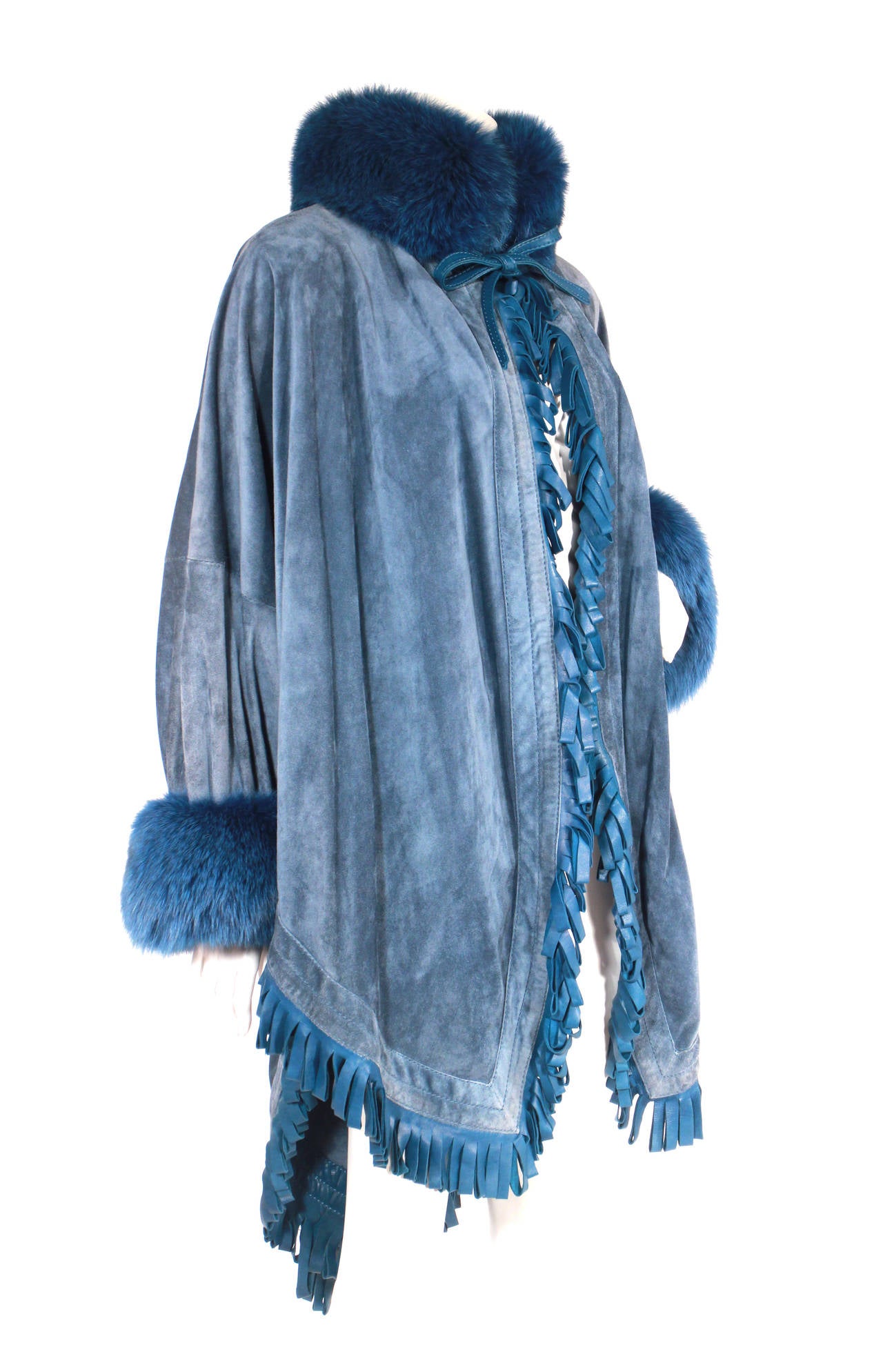 Christian Dior blue suede cape with fringed leather trim and fox fur collar and cuffs. The shape is beautiful on, gorgeous color, just an overall knock out Dior piece! Circa 1980s.

Originally owned by Regine Zylberberg, of the famed Regine night