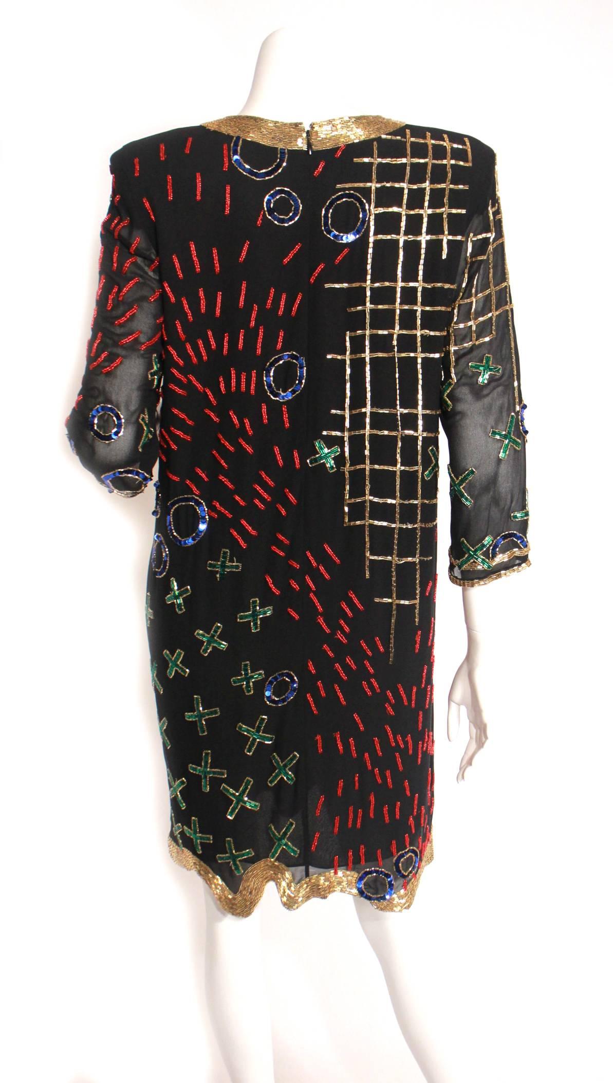 Vintage Fabrice shift style cocktail dress, circa 1980s. This super fun dress is perfect for the holidays!! It is adorned in blue, red, green, and gold bugle beads and sequins. Loving the x's and o's thru out the dress. Fully lined, zip back, wavy
