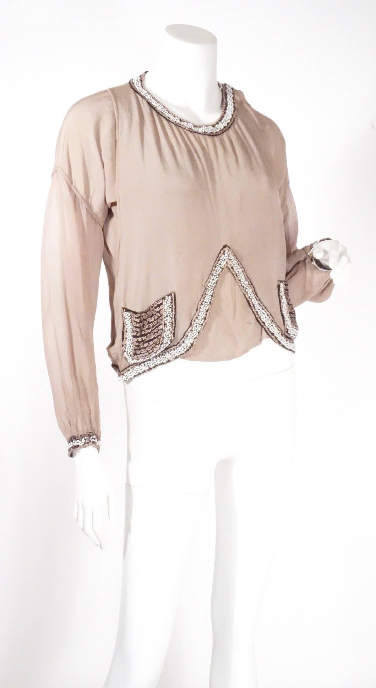 Vintage 1920s blouse. Features a beautiful stone color with two beaded pockets. This top has a stunning drape and can be dressed up or down. 