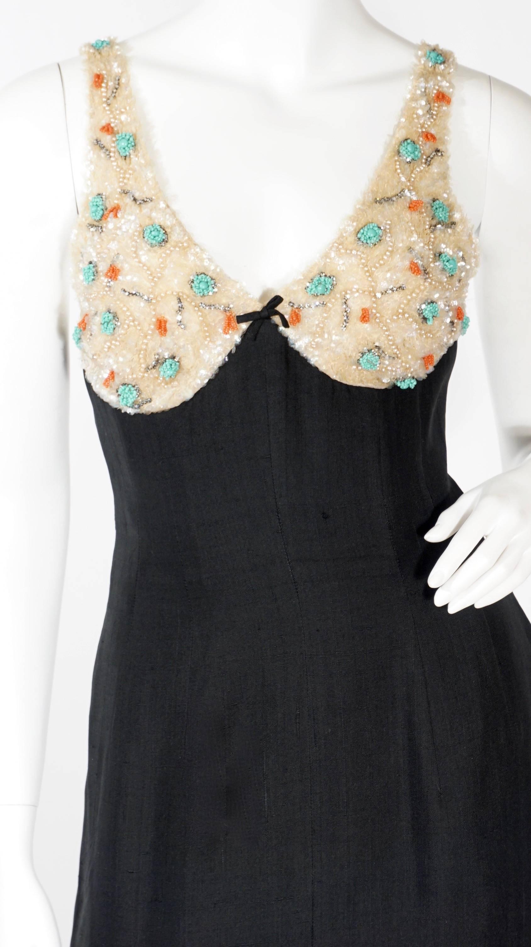 Not every bombshell gets to own a killer dress like this totally unique 1960s Mr. Blackwell original silk cocktail number with intricate beading in rhinestones, pearls and sequins along the boned bodice and straps. Very good condition.

