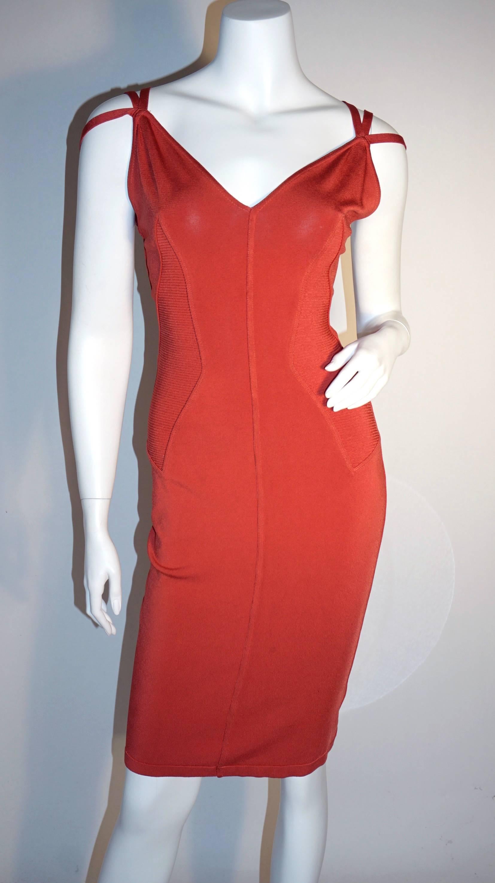 Circa 90s Alaia. This  bodycon dress features a gorgeous coral color, ribbed paneled sides, stretch material, and three straps on both shoulders. 

Very good condition. 
Photo on model via vettavintage (.com) -- Color shown better on the VV site.