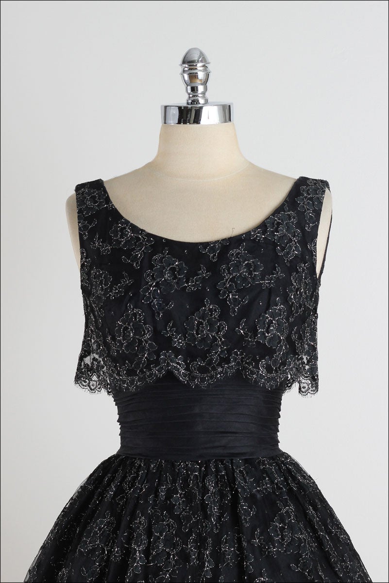 ➳ vintage 1950s dress

* black lace
* organza waist
* acetate lining
* pleated waist
* metallic stitched floral lace
* metal back zipper
* by Suzy Perette

condition | excellent

fits like xs

length 42