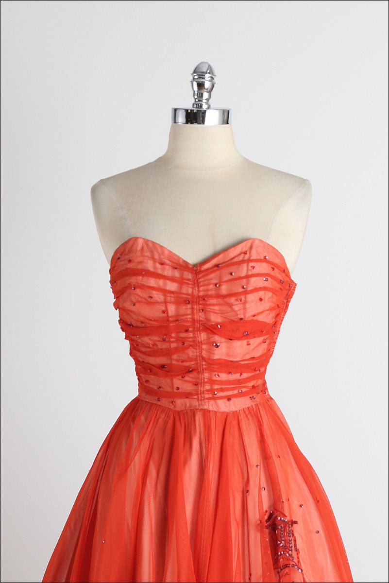 ➳ vintage 1950s dress

* fire red/orange tulle
* acetate lining
* black sequin spider webs scattered around skirt
* metal side zipper
* truly amazing and rare design by Gothe

condition | excellent

fits like xs/s

dress length