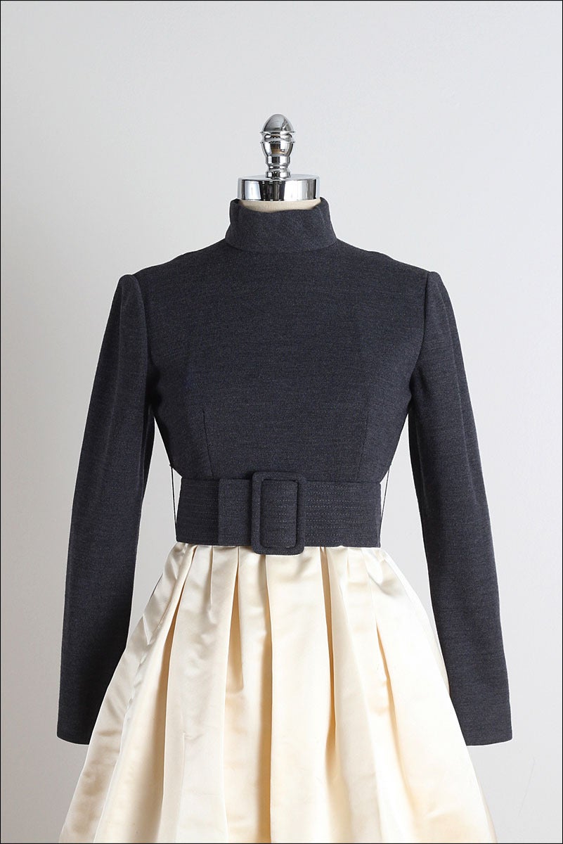 ➳ vintage 1960s dress

* gray wool
* ivory satin
* acetate lining
* detached belt
* bubble hem
* back zipper
* by Chester Weinberg

condition | excellent

fits like xs/s

length 39
