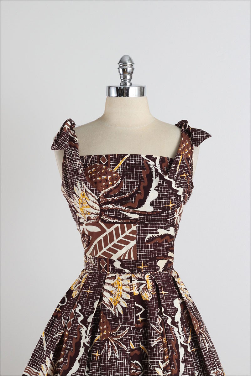 ➳ vintage 1950s dress

* Hawaiian tiki print cotton
* pleated skirt
* tie shoulders
* metal back zipper
* by Liberty House

condition | excellent

fits like xs/s

length 45