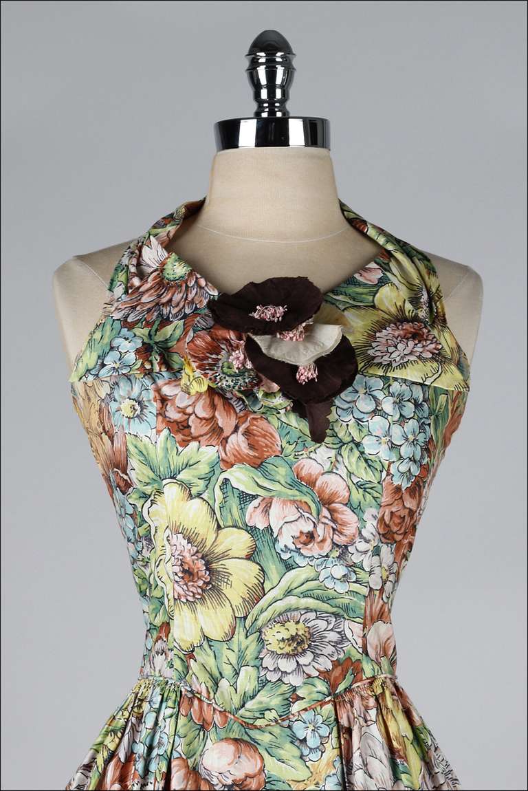 vintage 1950's dress

* lovely polished cotton in a floral print
* halter neck with ties
* poppy flower corsage
* metal back zipper
* by Paul Sachs

condition | excellent - few small spots on corsage 

fits like medium

length